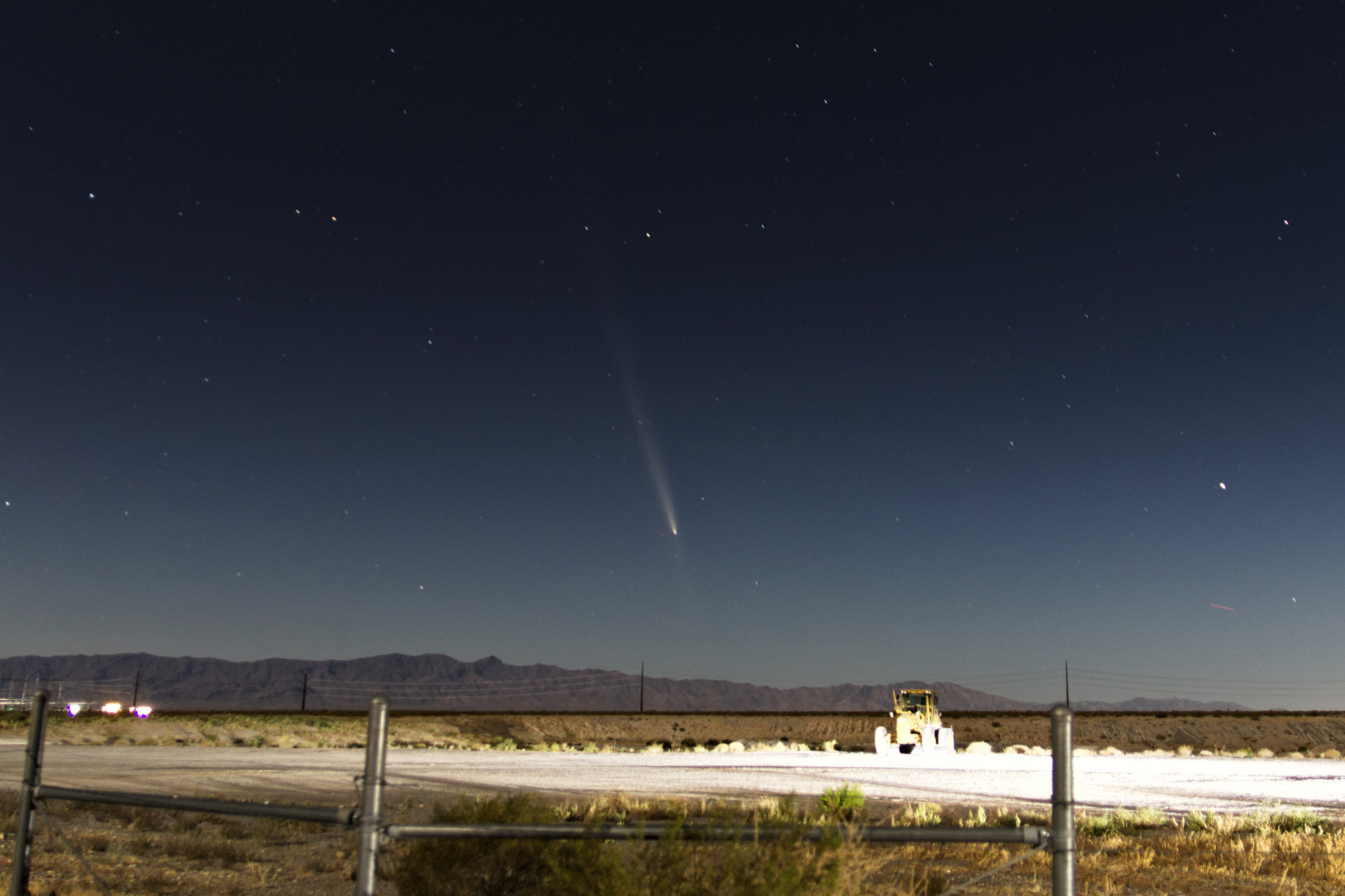 Comet C/2023 A3 Tsuchinshan-ATLAS over a low desert mountain horizon, the headlights from someone's truck illuminating a construction vehicle in the near field.

Exposure: 30s
ISO: 200
F-Stop: 2.8
Focal: 17mm