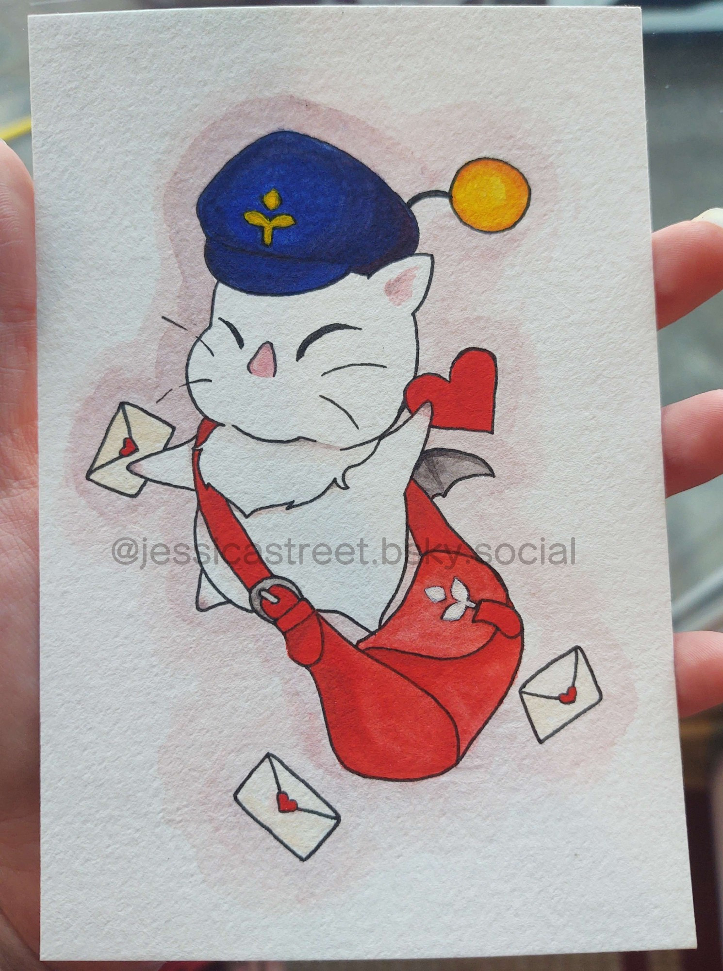 Delivery moogle holding a heart card in one paw and an envelope with a heart shaped sticker seal in the other paw. A couple envelopes surround him. He wears a blue hat and has a red bag.