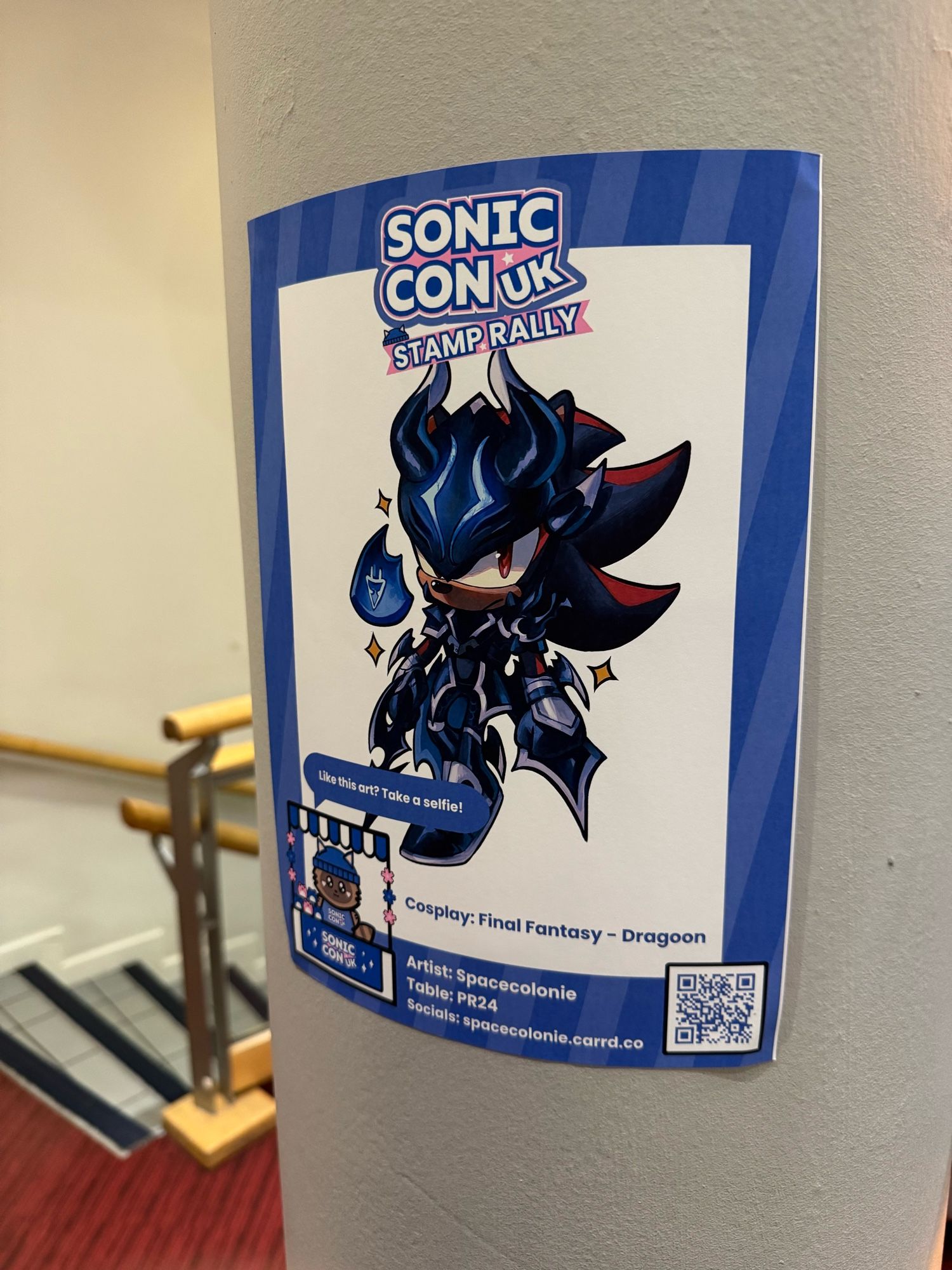 a photo of a poster, showing shadow (a black and red anthro hedgehog) wearing an outfit inspired by the dragoon class from final fantasy (specifically final fantasy 14?)