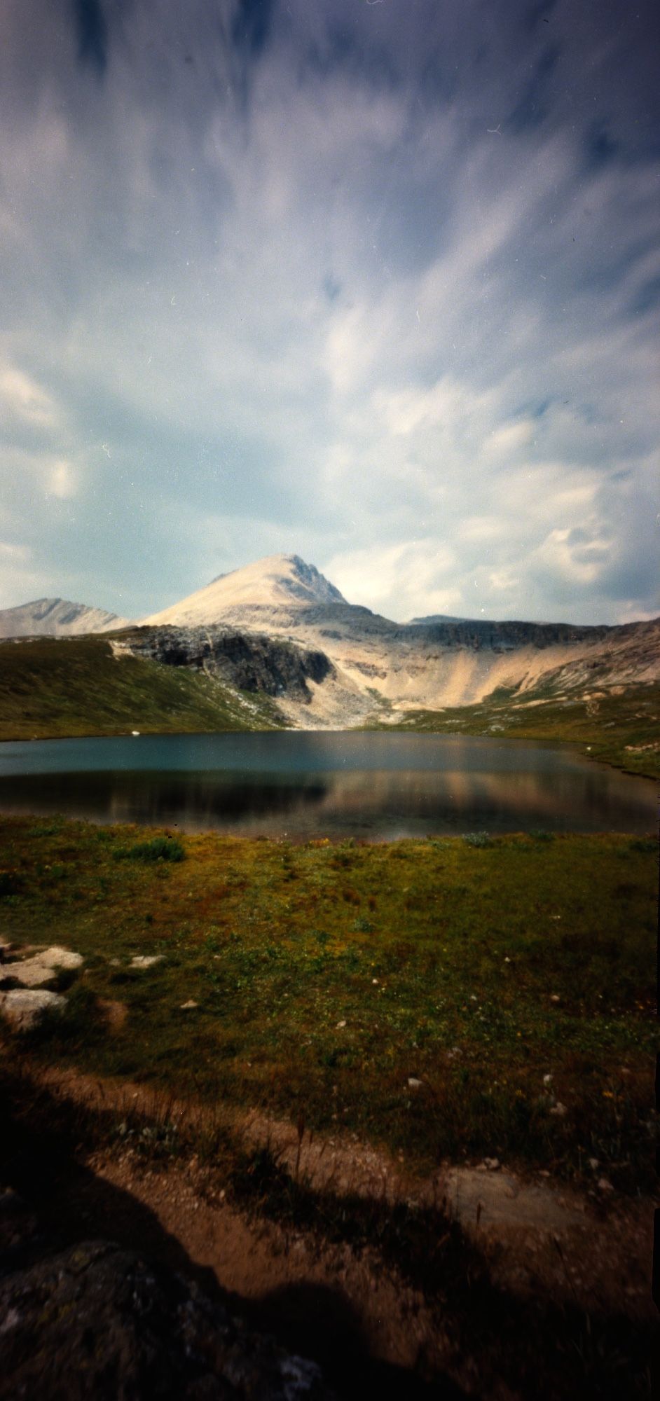 vertical 6x12cm colour pinhole photograph of Helen Lake, an alpine lake located along the Icefields Parkway in Banff National Park