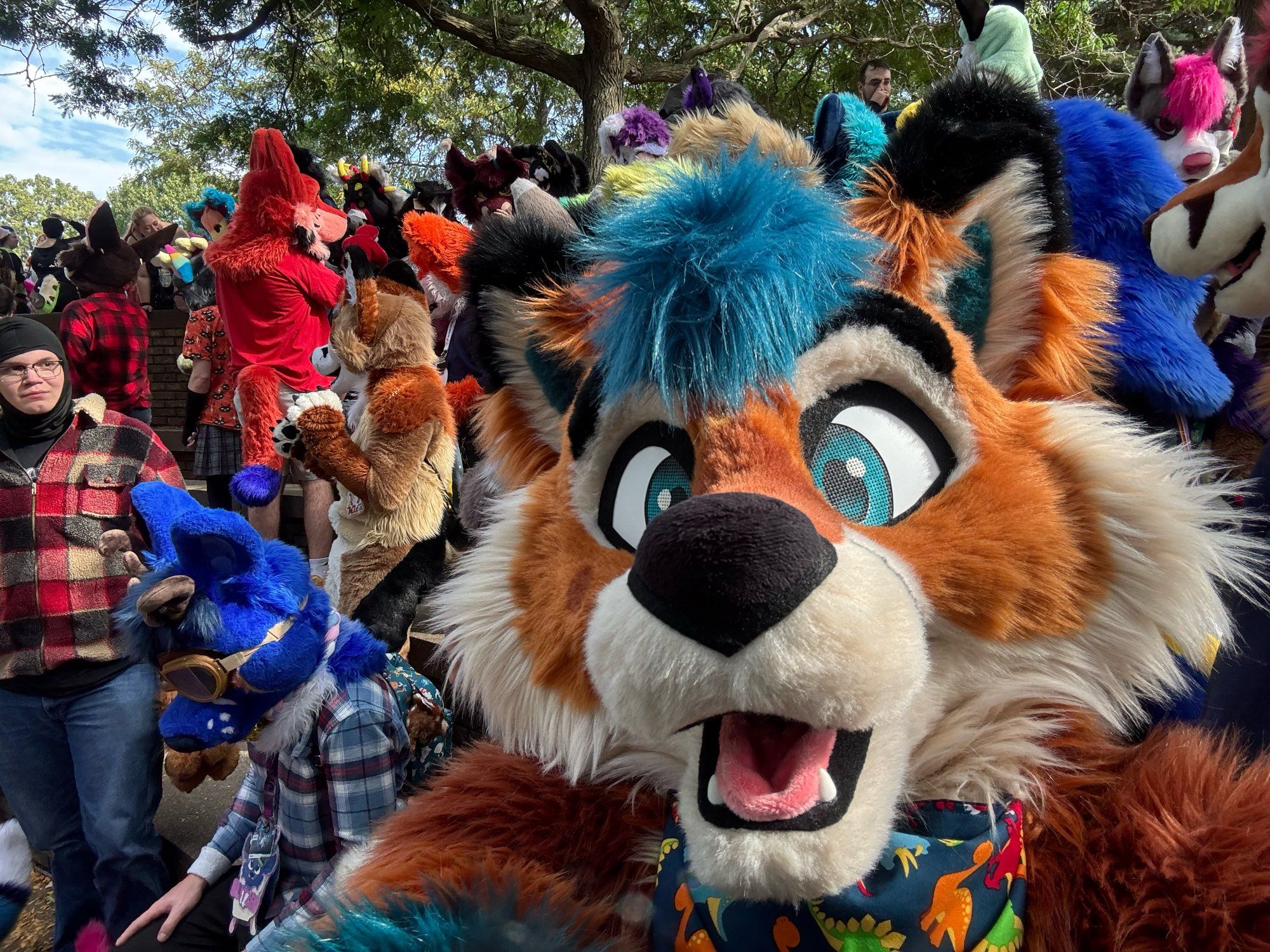 A fox fursuiter takes a selfie with a group of other furries