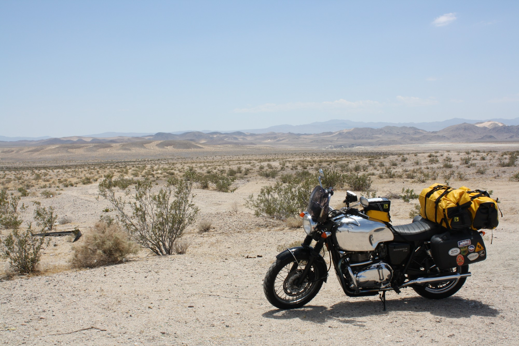 My heavily modified 2006 Triumph Bonneville T100 in front of a Mojave Desert landscape.