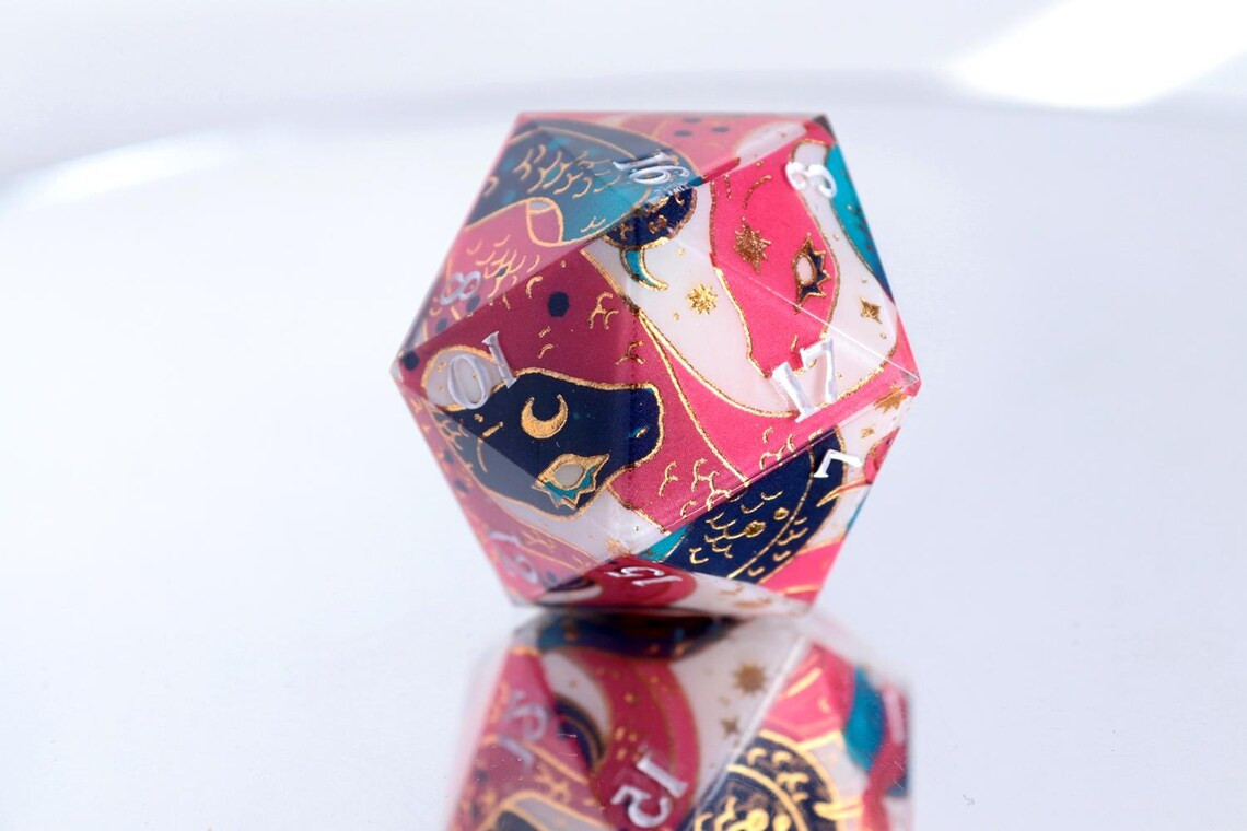 A pair of two snakes curled arround a big D20 dice. One of the snakes is pink and the other one is blue over a white background and with some golden accents decorating the pattern.