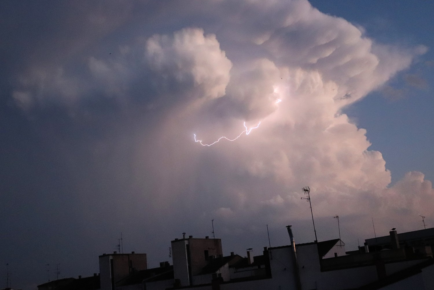 Two lightingbolts striking inside a cloud