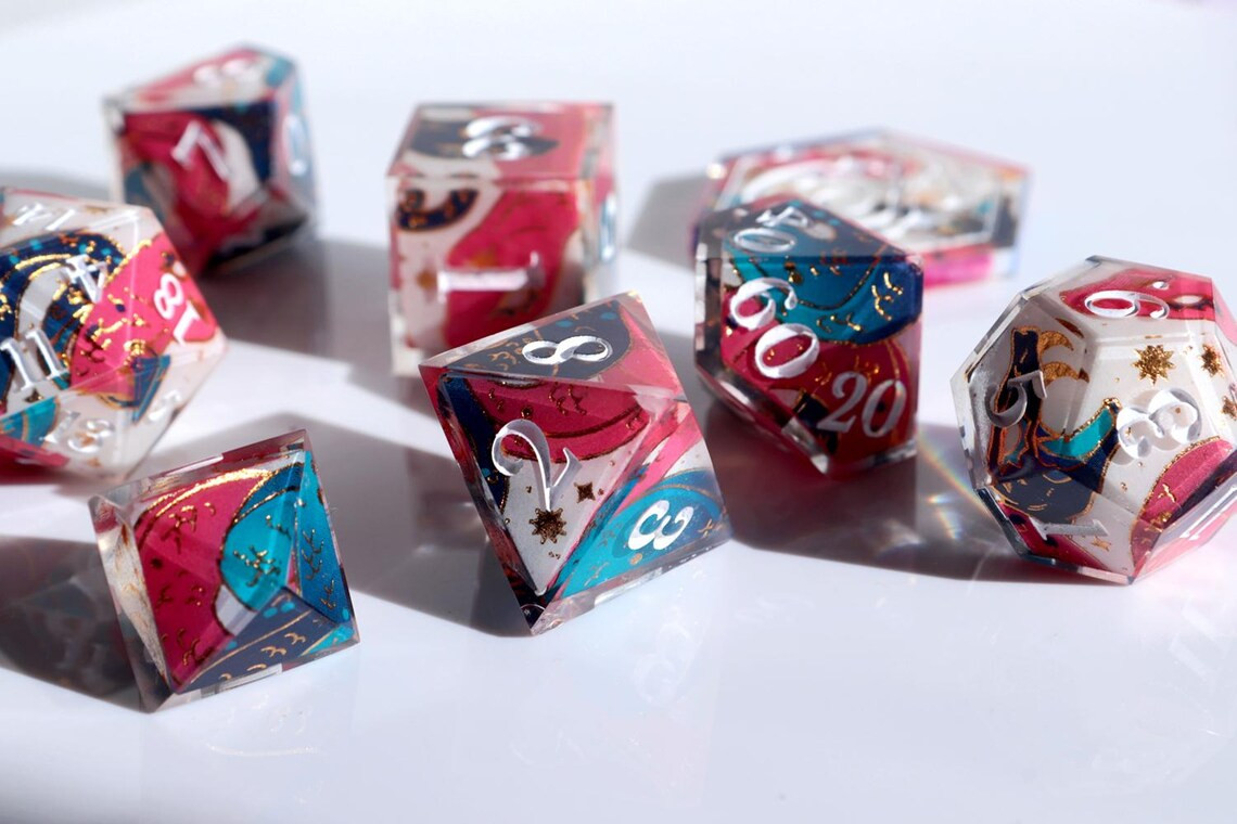 A pair of two snakes curled arround a ttrpg dice set. One of the snakes is pink and the other one is blue over a white background and with some golden accents decorating the pattern.