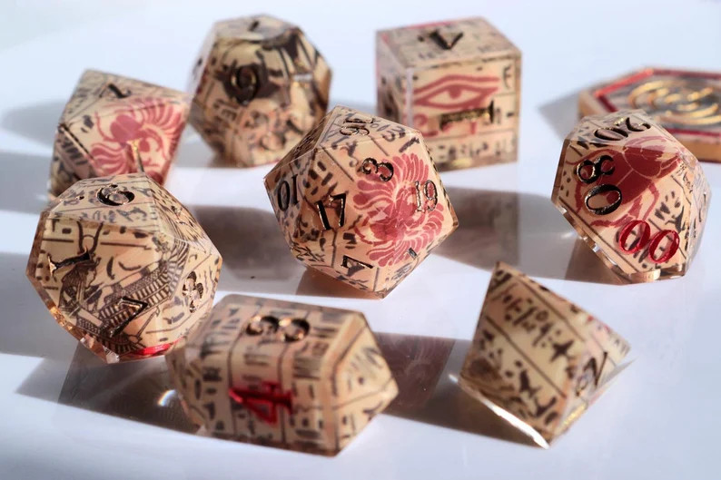 A dice set decorated with egyptian hieroglyphs