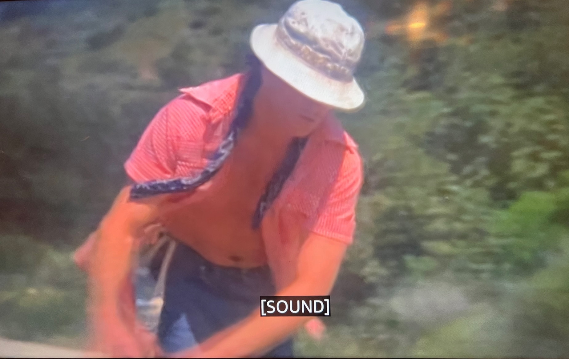 Screen cap of a movie and the closed caption just reads [SOUND]