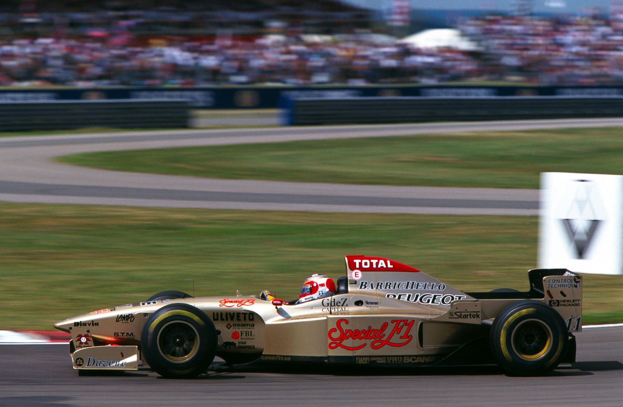 Side shot of Barrichello driving the Jordan around Silverstone.