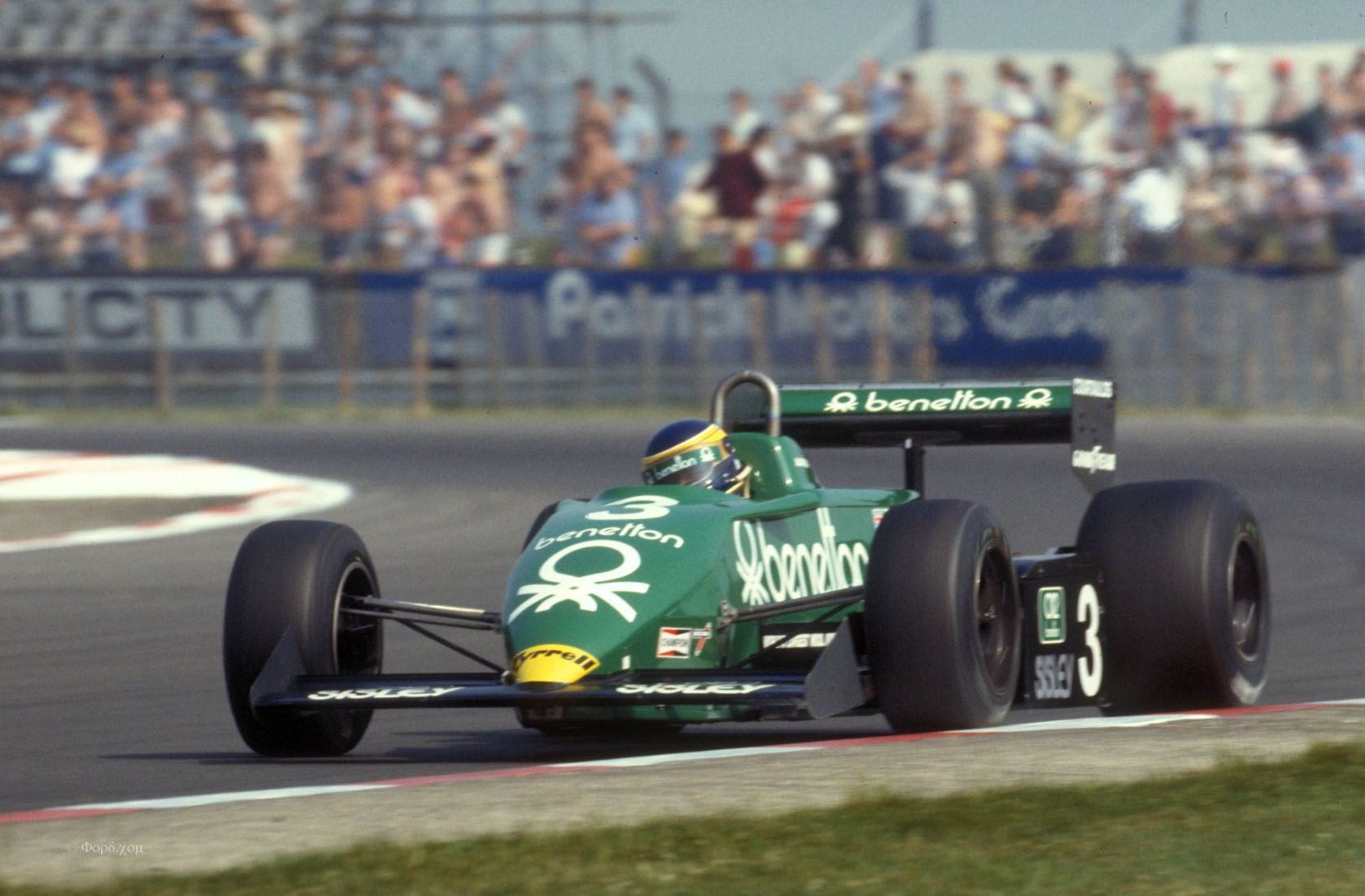 3/4 frontal picture of Alboreto driving through the exit of the Club corner.