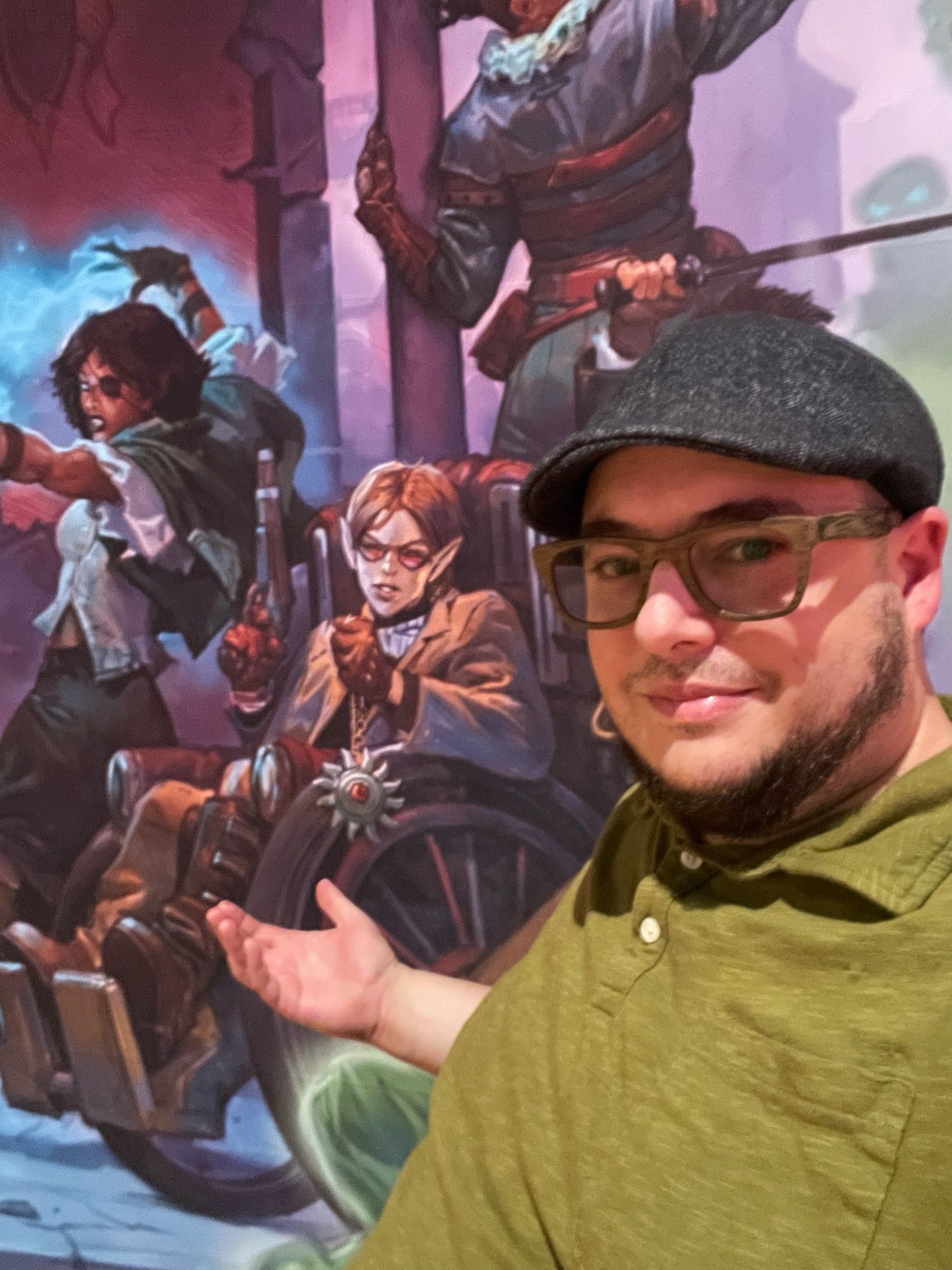 A piece of key art at the Wizards of the Coast event that showcases an adventure using a wheelchair along with me… in my wheelchair