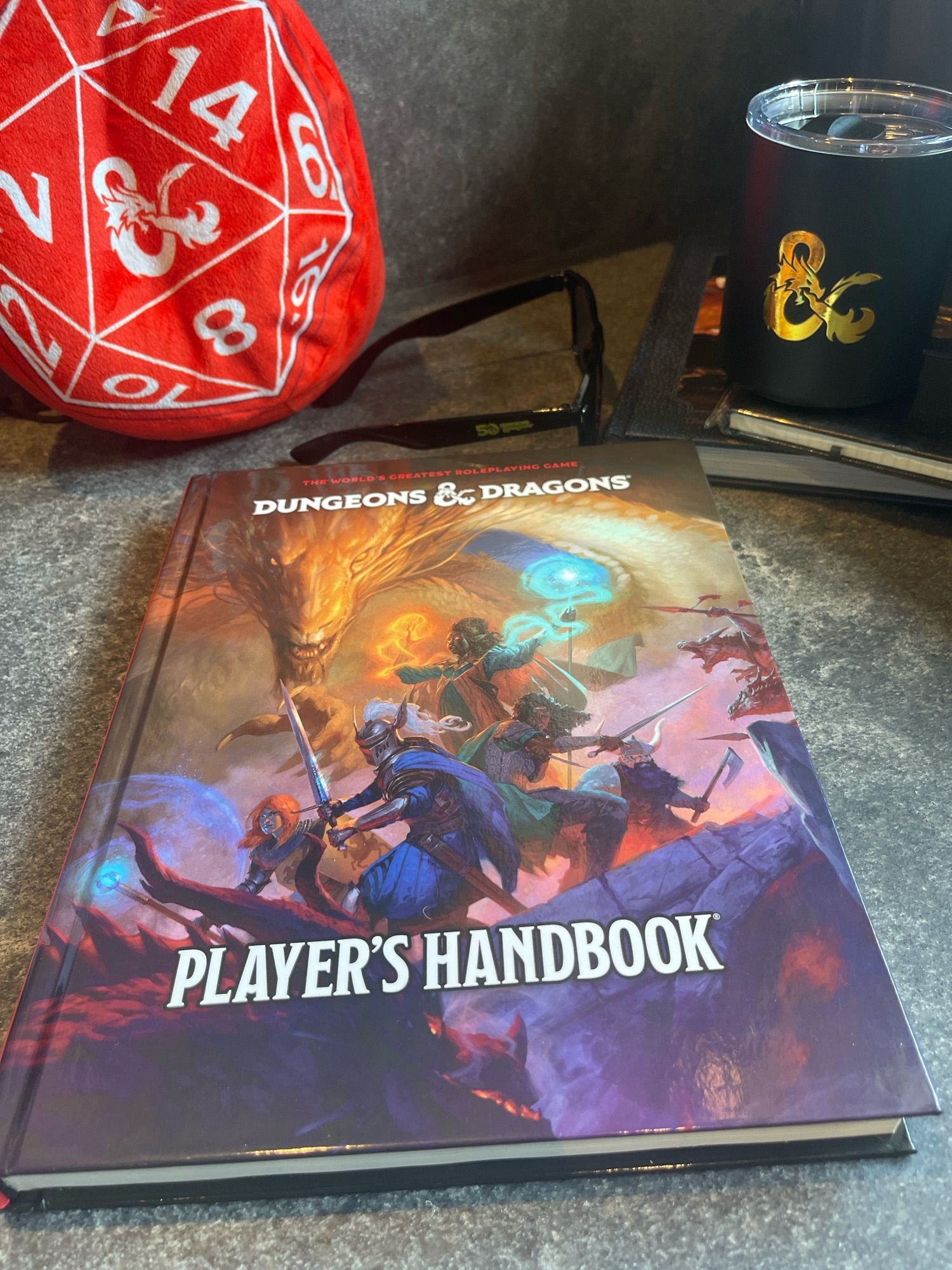 The 2024 Players Handbook along with some WotC sunglasses, mugs, and other assorted goodies