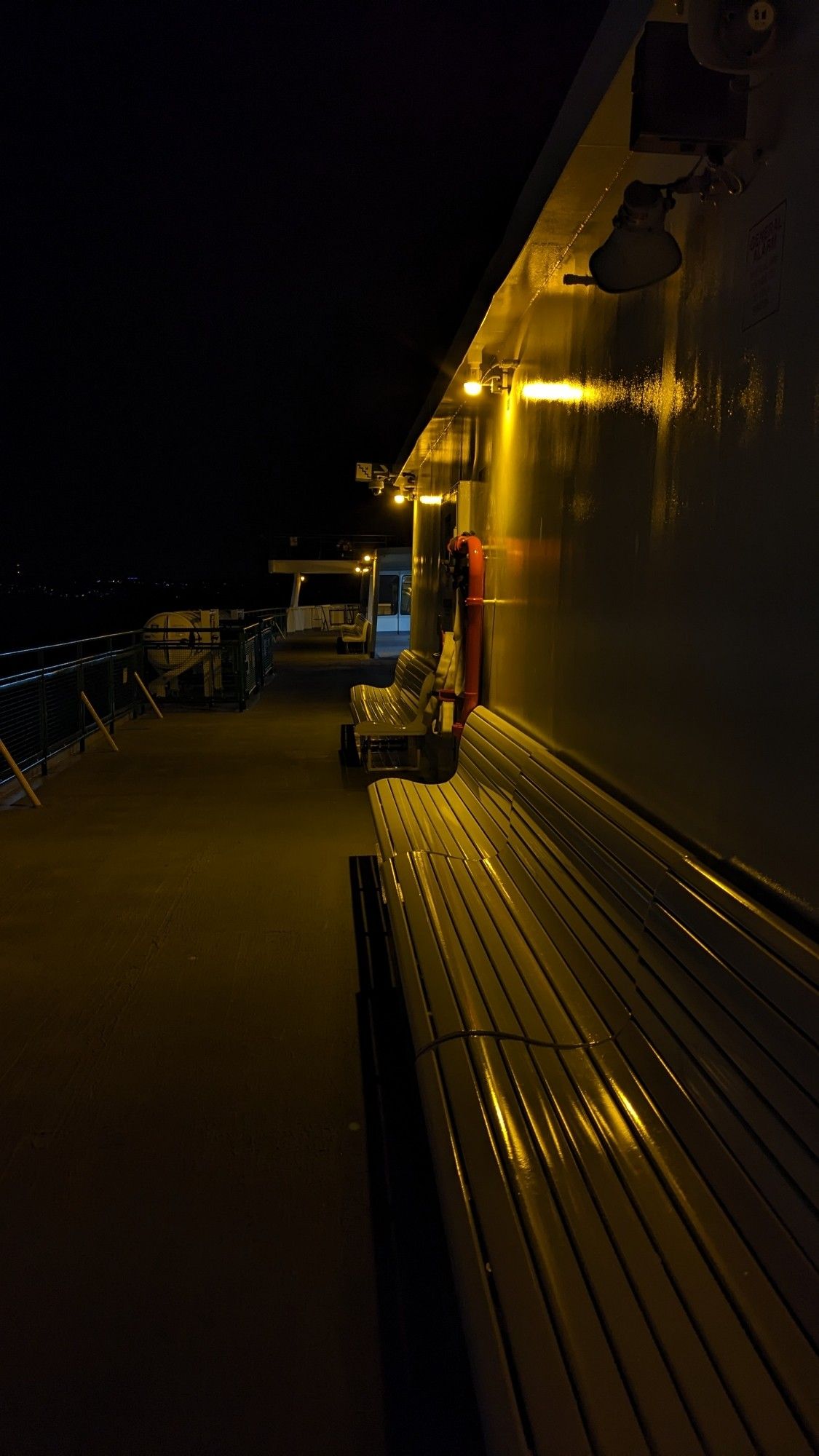 On a ferry over Puget sound in darkness with a few lights.