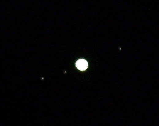 Jupiter overexposed but with three moons visible in orbit.