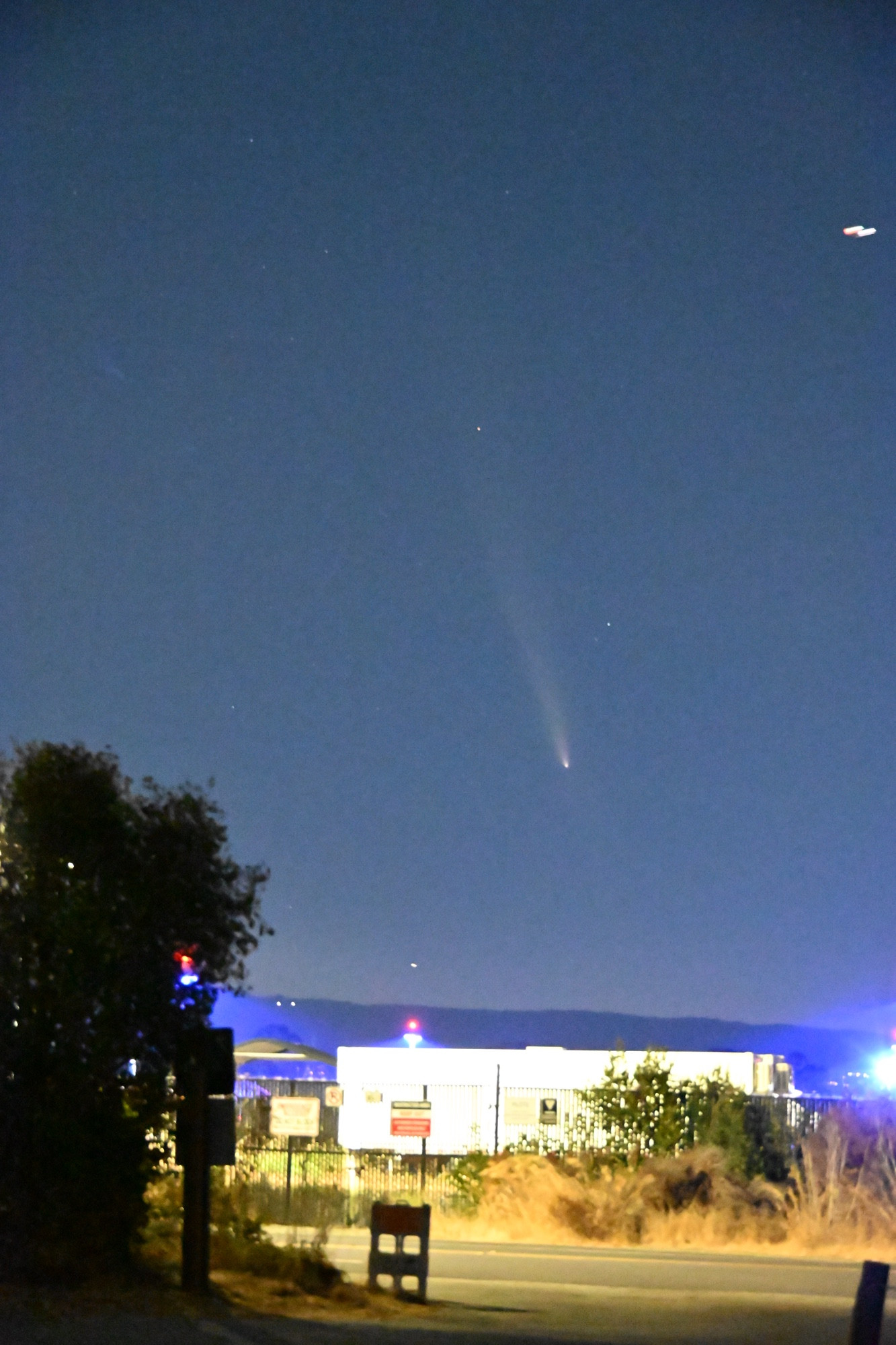 A picture of a comet over a building 