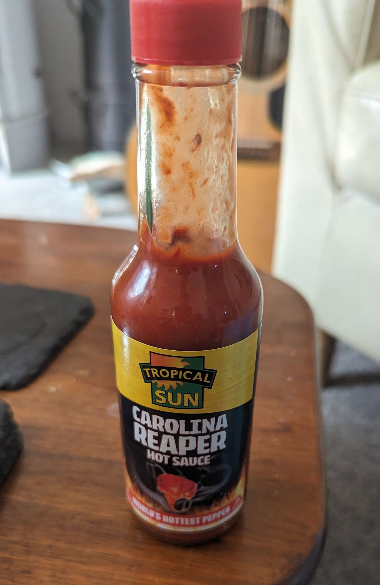 Photo of a bottle of Tropical Sun Carolina Reaper hot sauce bottle.