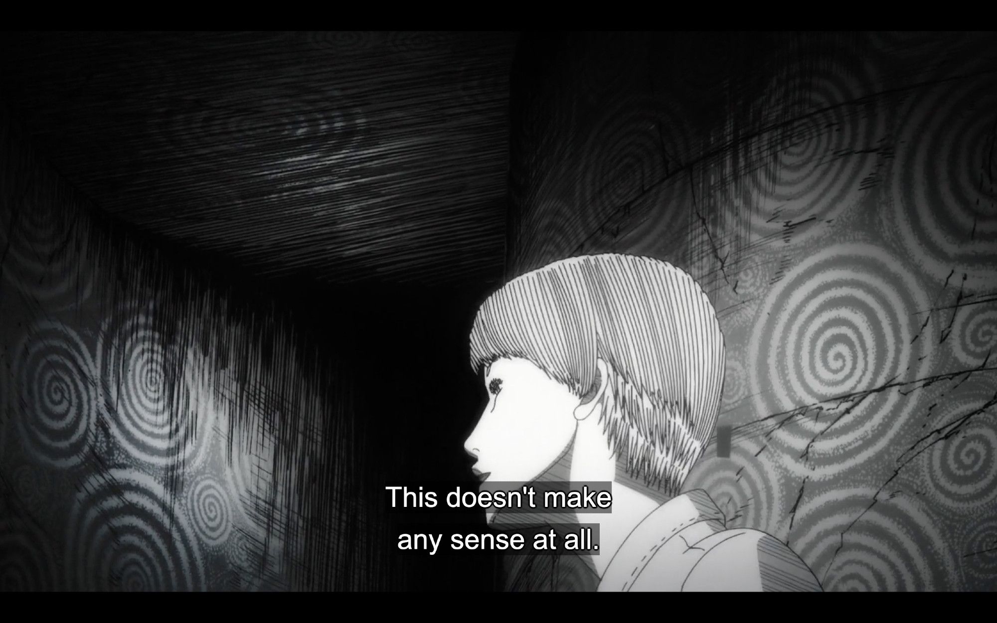 woman walks up spiral staircase, walls patterned with spirals, subtitle reads "This doesn't make any sense at all"