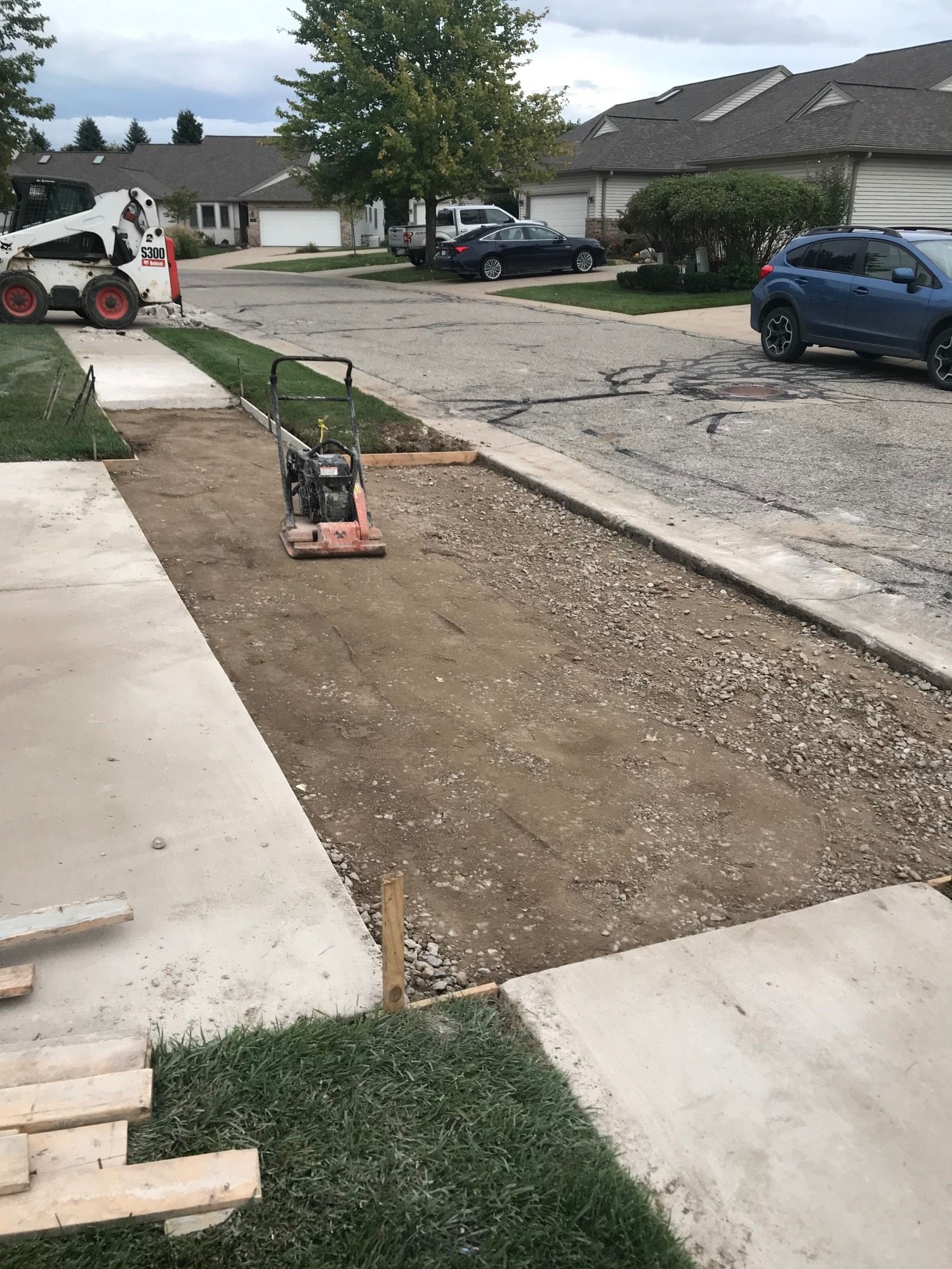 Driveway and sidewalk awaiting framing