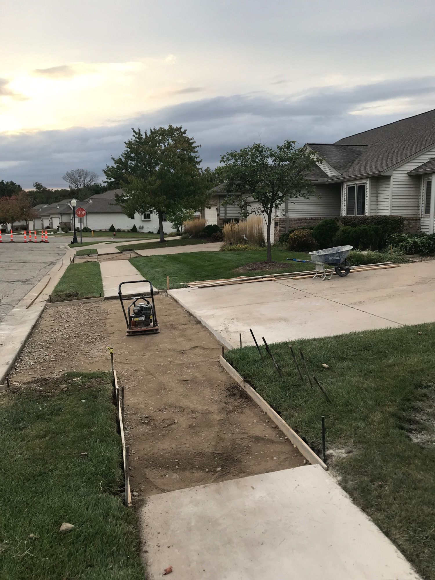 Driveway and sidewalk awaiting framing