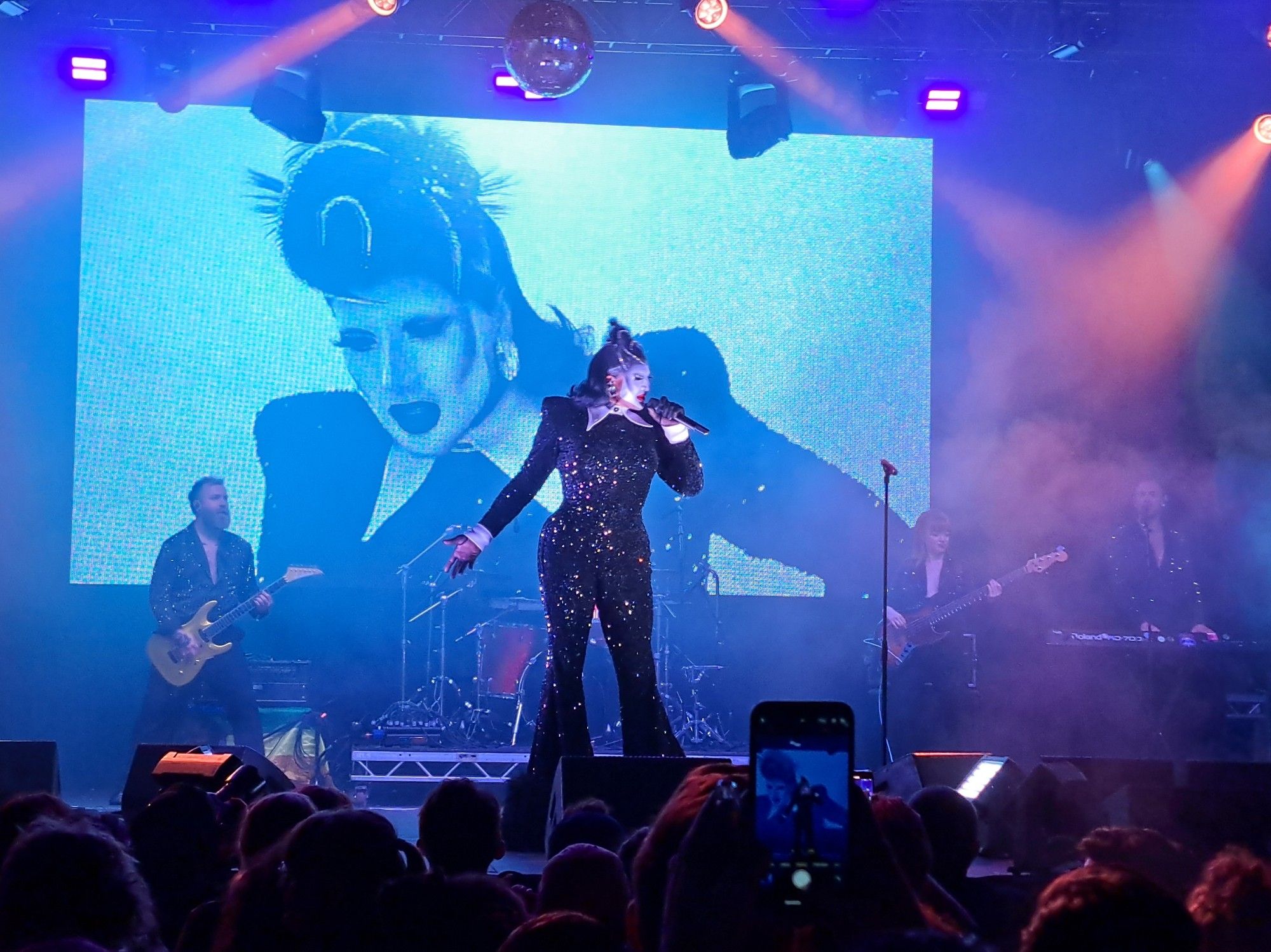 A photo of drag queen Dannh Beard fucking belting Simply The Best at Manchester Pride.