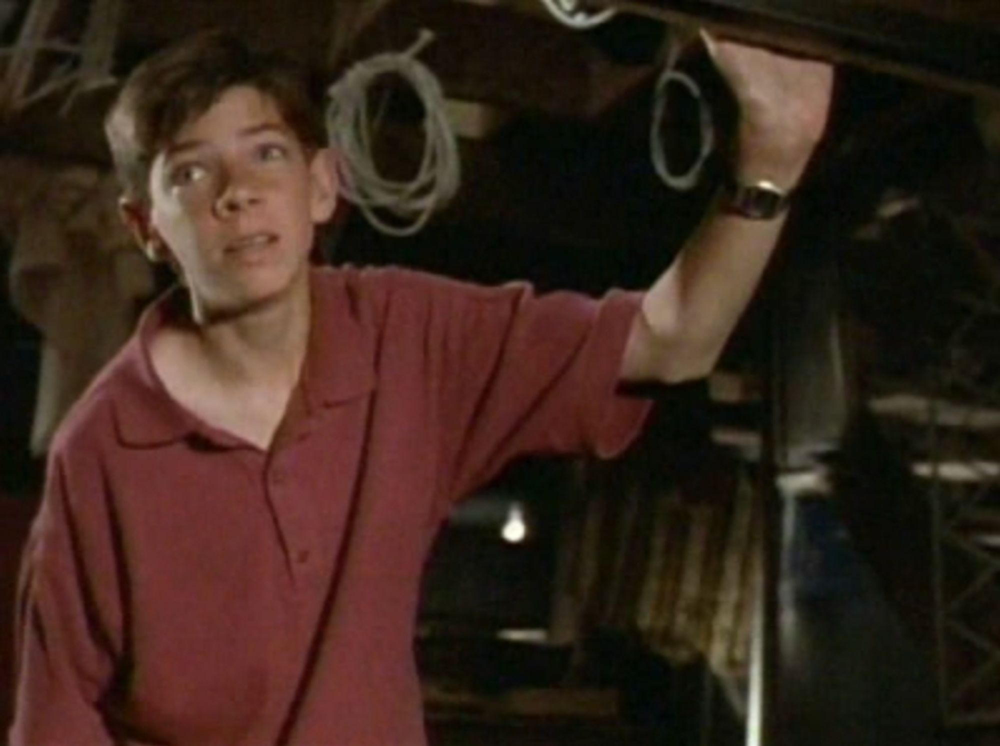 Graham Selkirk as "Andy Carr" in the 1992 episode of Are You Afraid of the Dark titled, "The Dark Music." He resembles a 13-year-old John Mulaney. He is looking apprehensively at the darkened basement of his home.