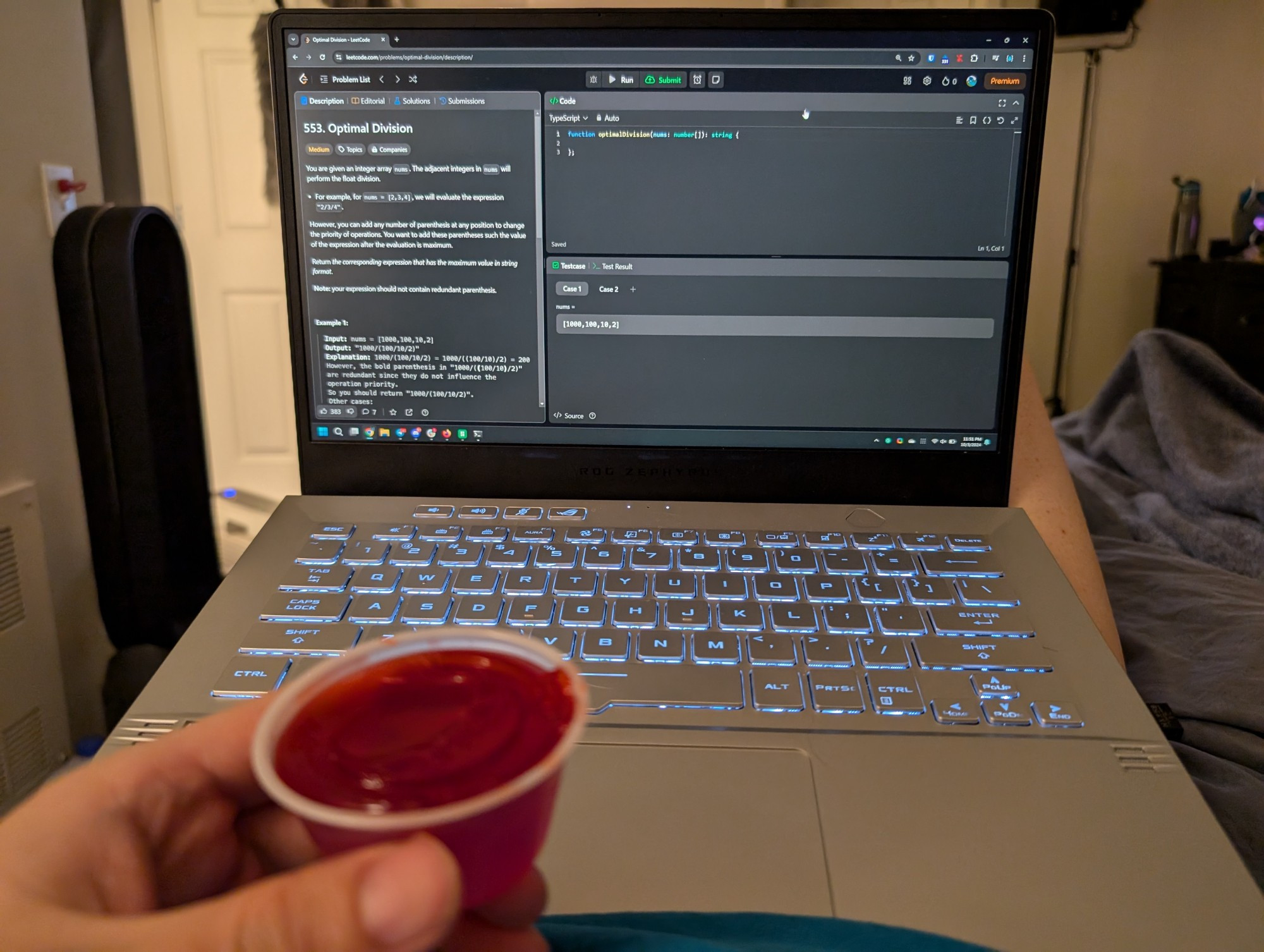 me holding a jello shot in front of a laptop that has a leetcode question open