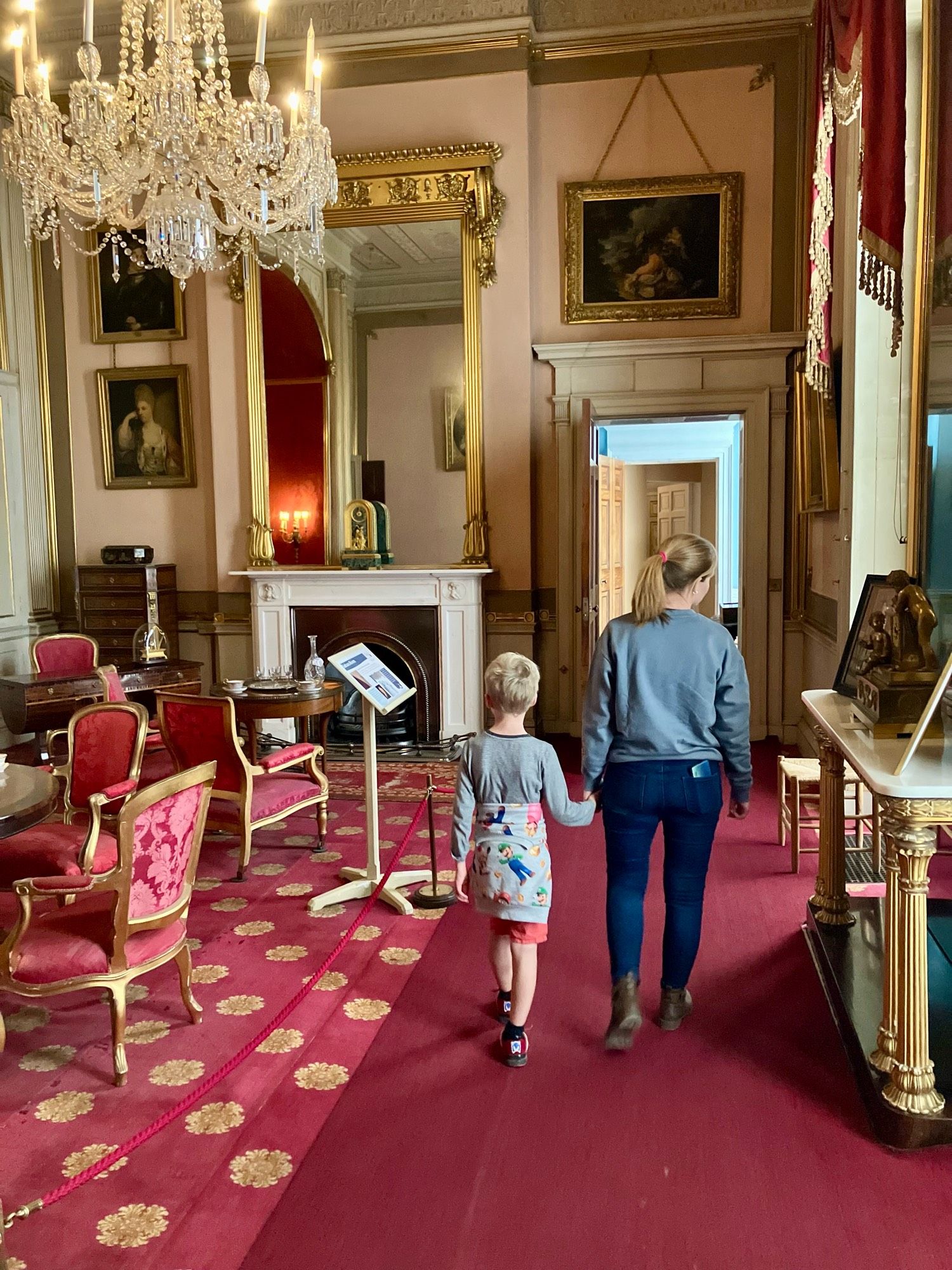 Boy and his mum walking through the interior of Attingham Park