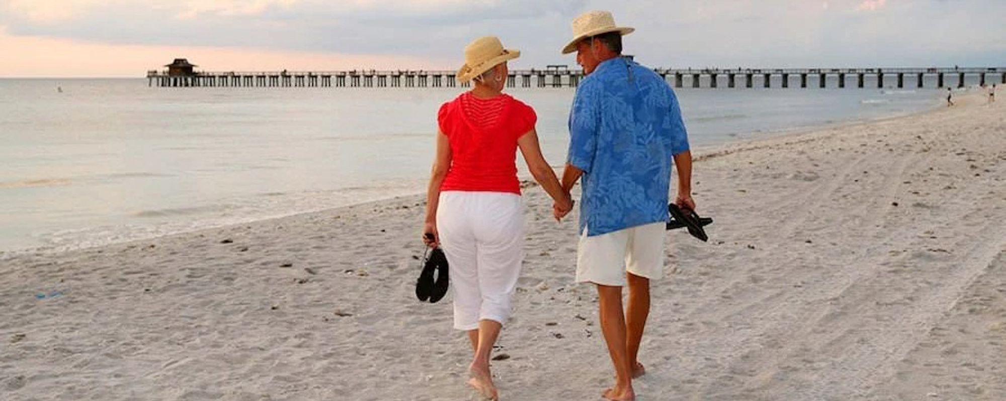 couple walking beach in Naples Florida