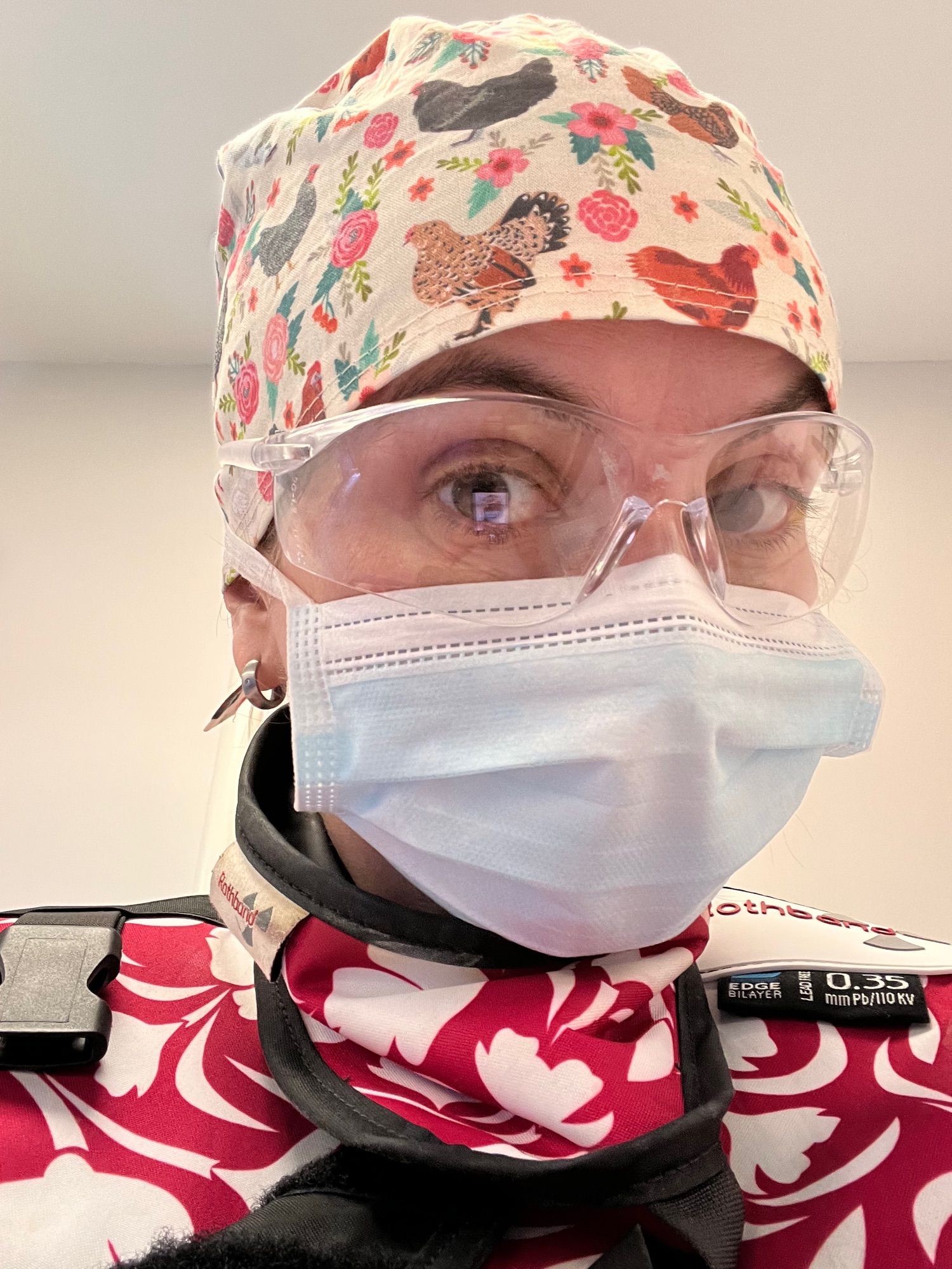 Selfie : surgeon with chicken pattern surgical cap, safety goggles, surgical mask and wearing leads