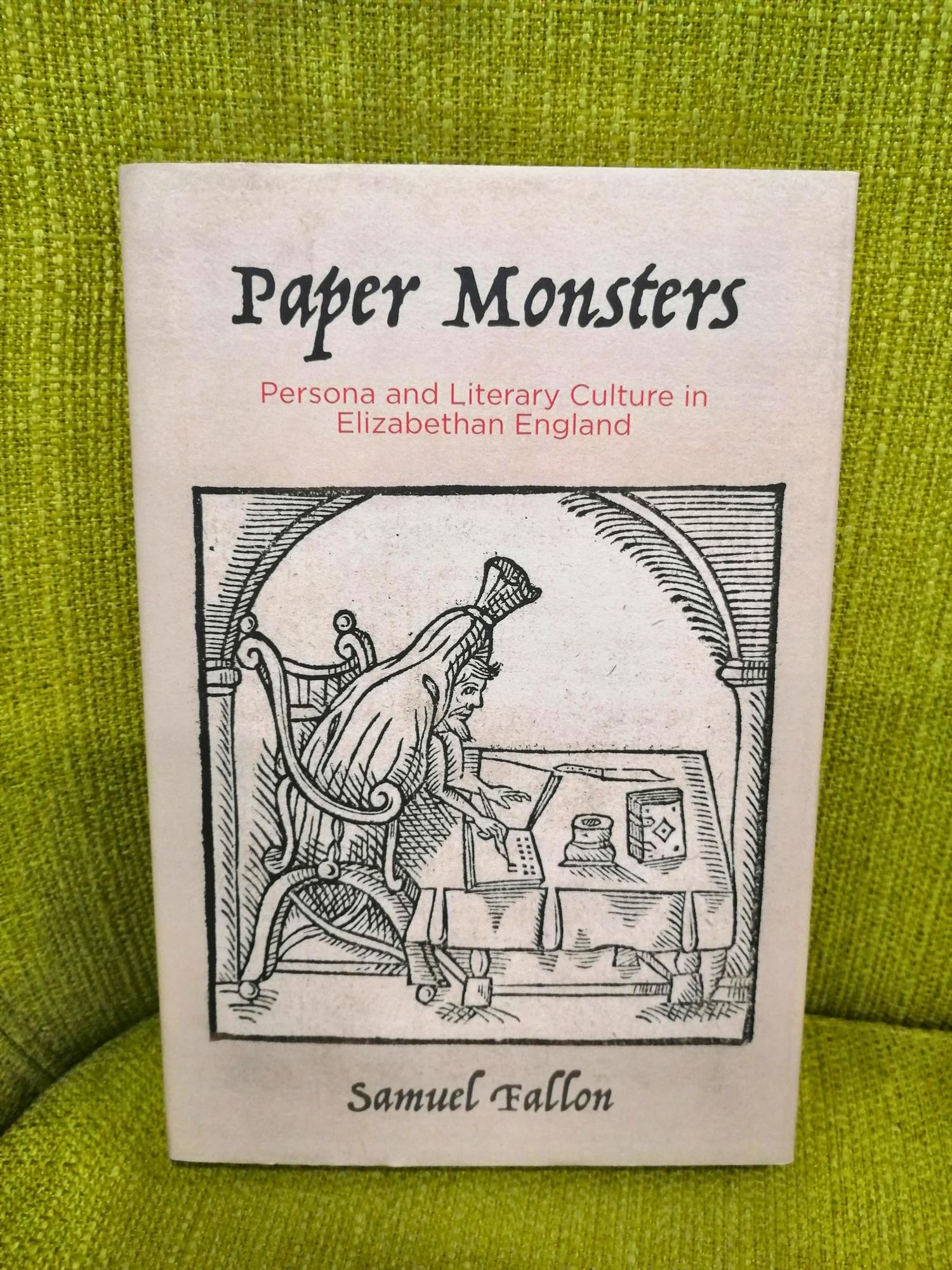 The book Paper Monsters propped up on a lime-green chair