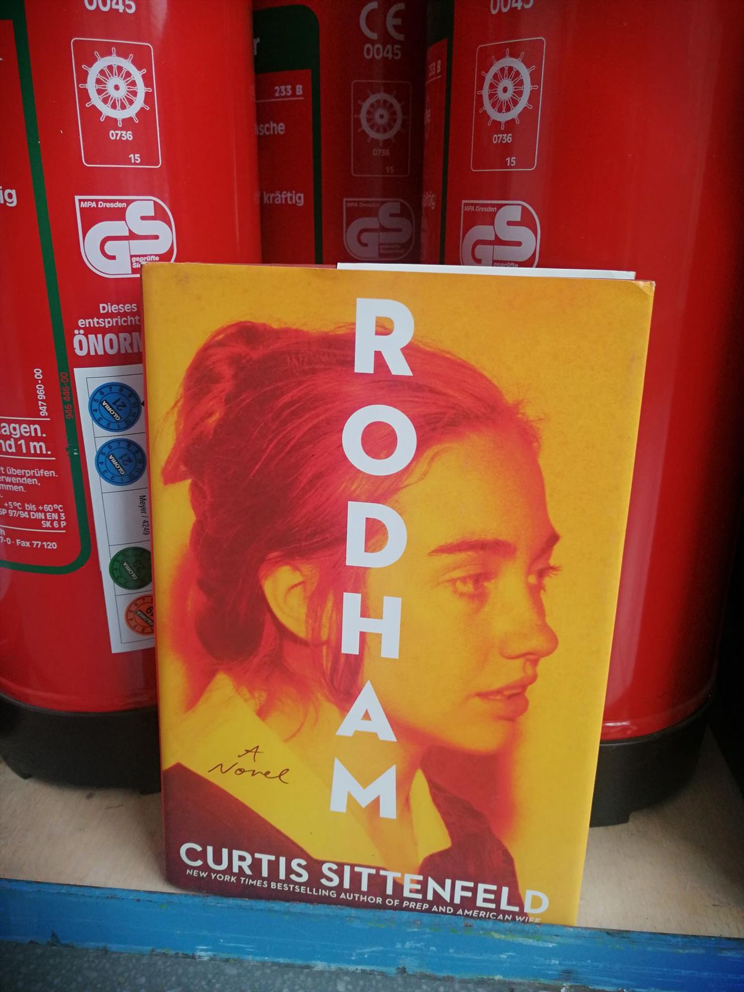 The novel Rodham in front of several fire extinguishers