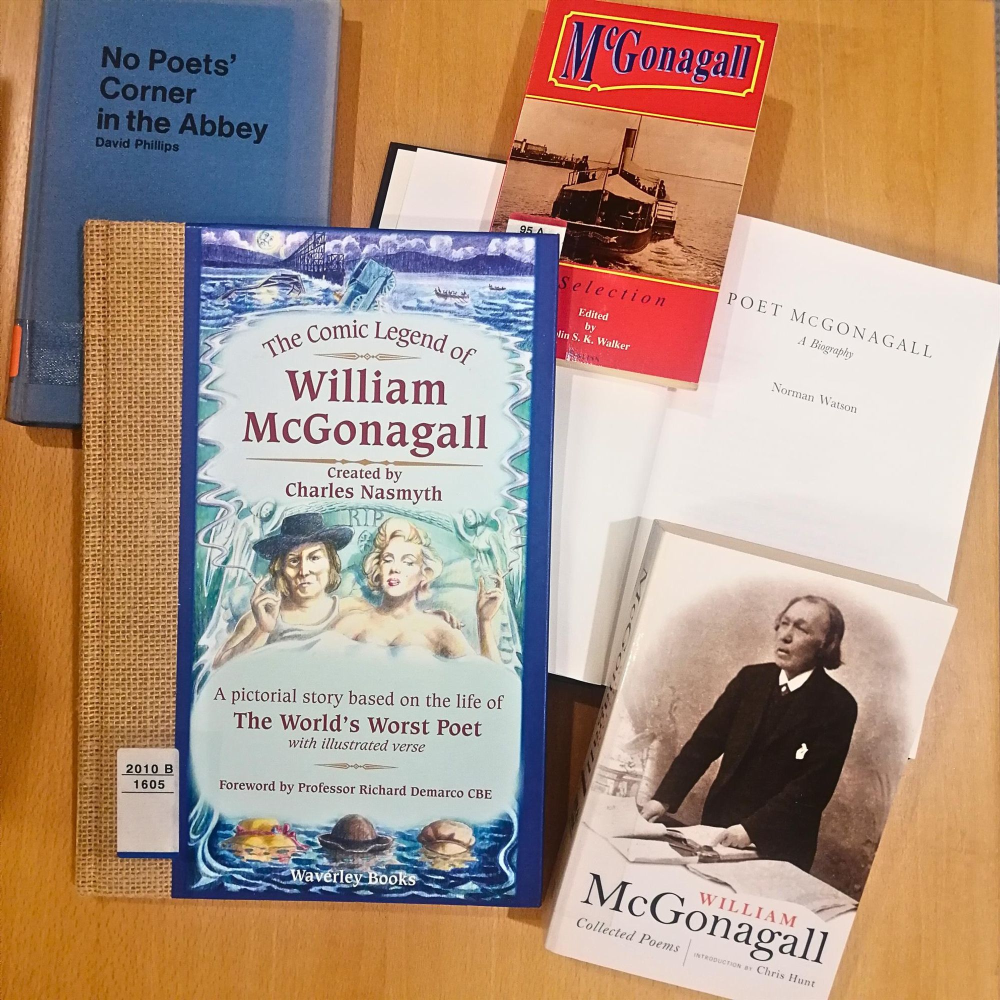 5 books on and by William McGonagall are spread on a wooden table