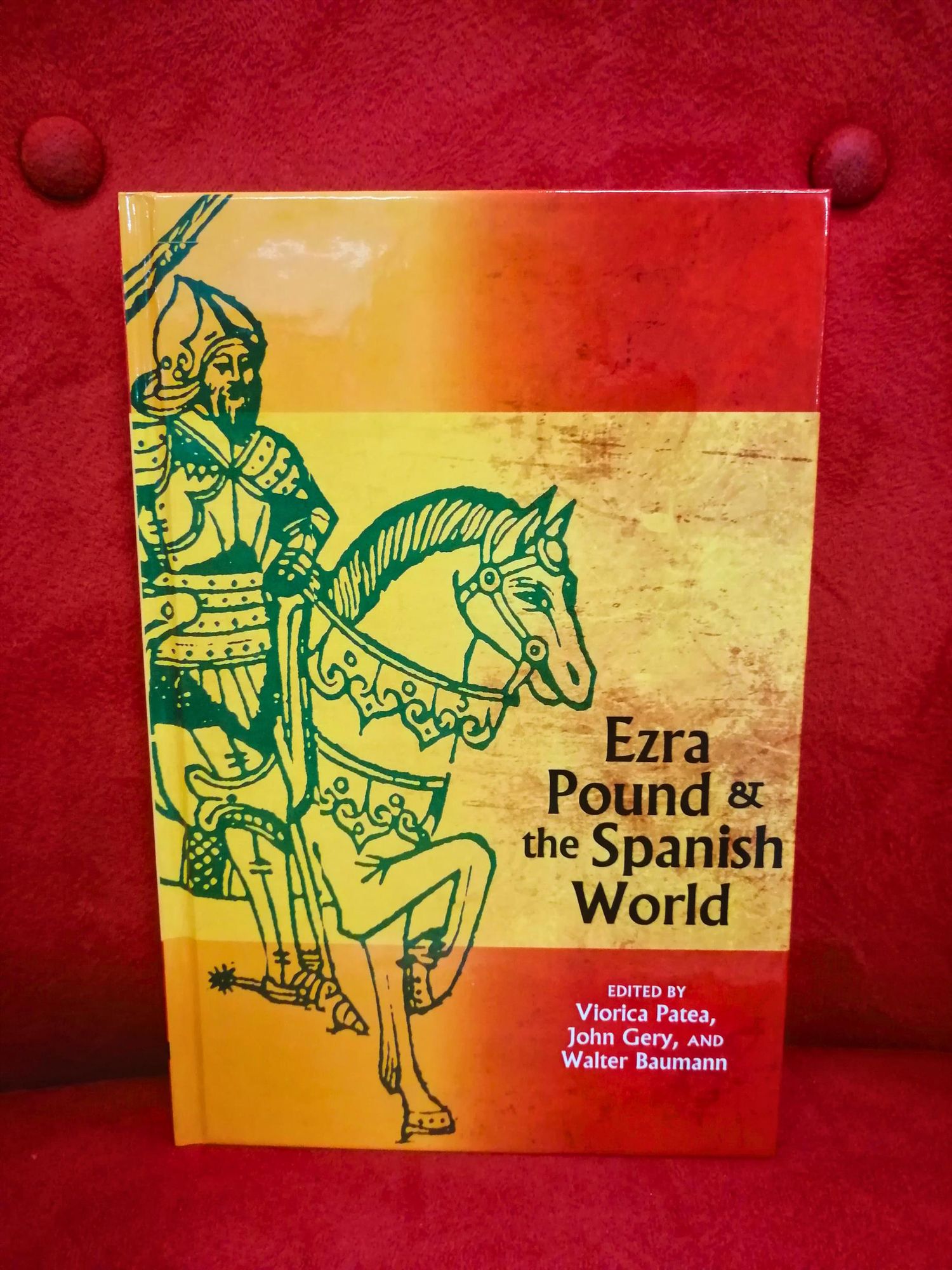 The the essay collection "Ezra Pound & the Spanish World" on a red sofa