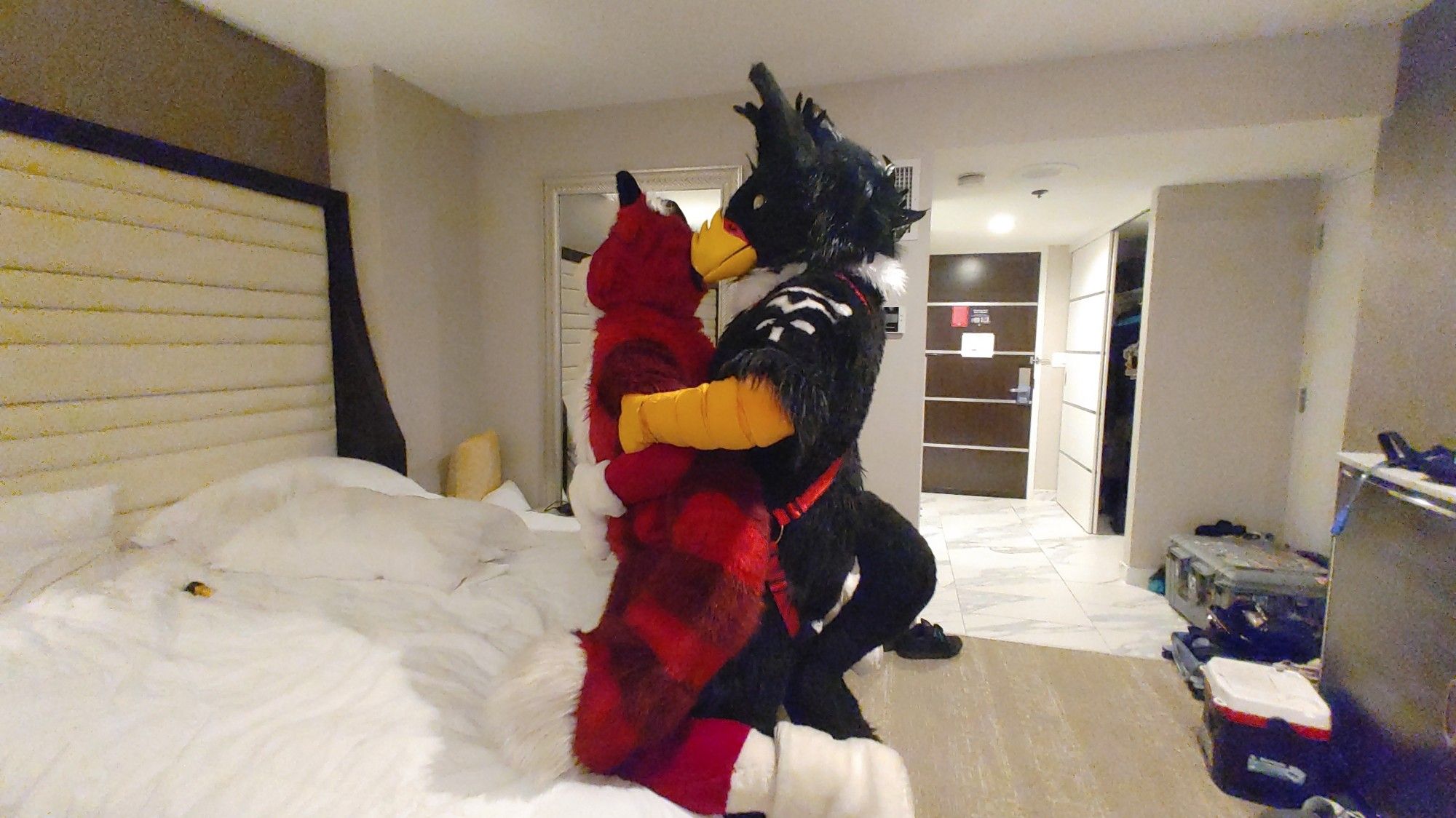 Storm Gryphon fucking a red fursuiter against the bed, pulling their arms against him as he thrusts up into their ass deep.