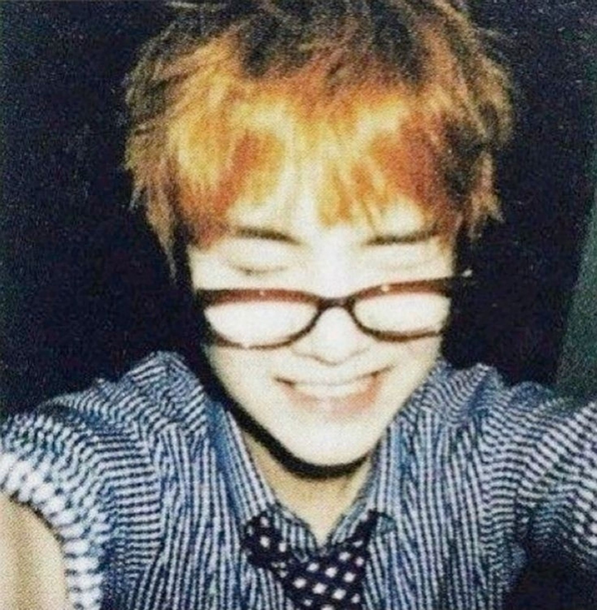 yoongi wearing glasses taking a selfie. He has his eyes closed and is smiling. looks like it's a polaroid pic, or it's just a vintage filter.