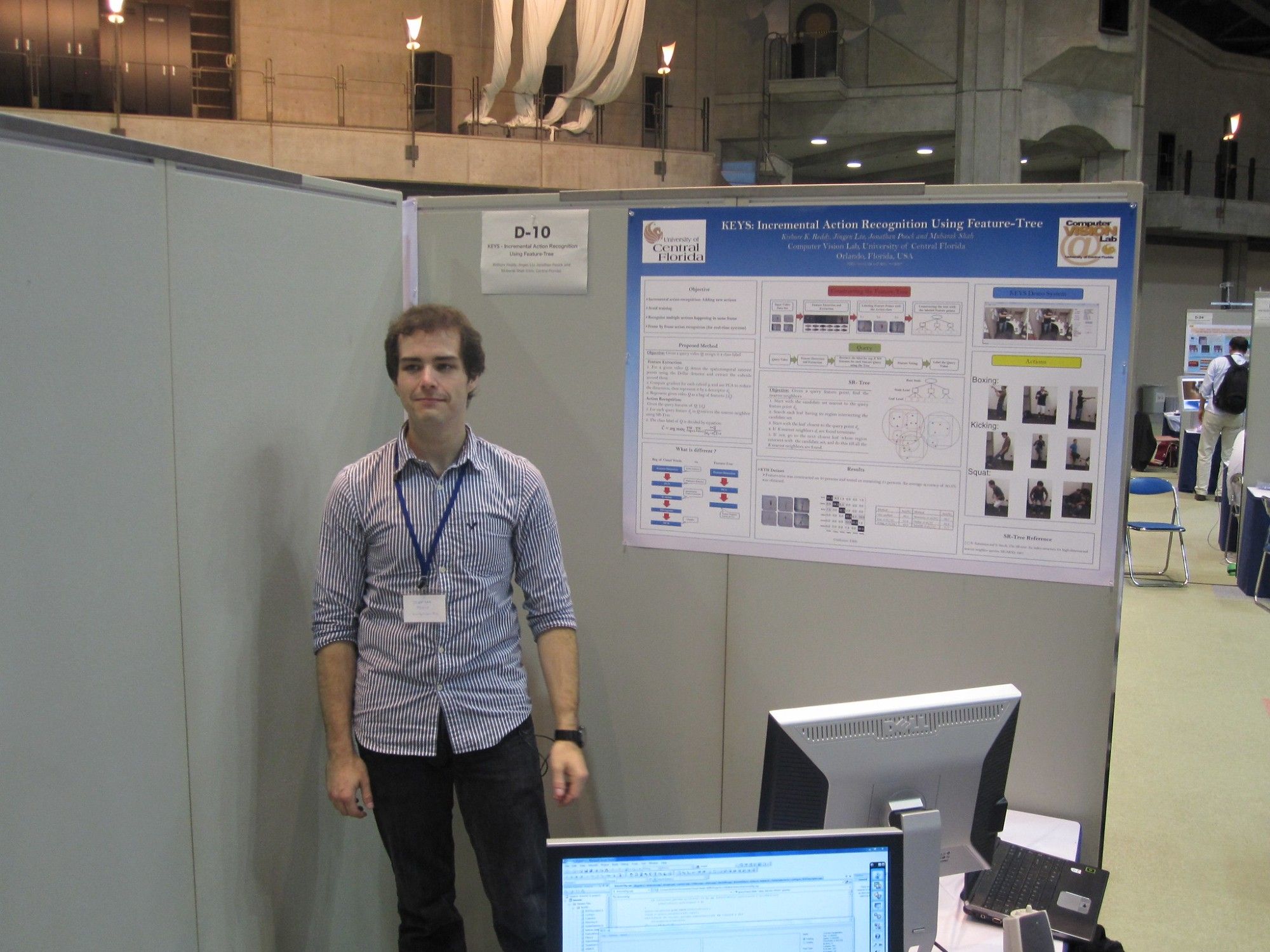 i'm standing in front of my demo at ICCV 2009. My colleague Kishore extended a labmate's bag of visual words approach; I took it and ripped it apart, rewrote it in C++ and made it a realtime demo. in 2009. I was downscaling hd video to a point that I was surprised we were getting any features at all, let alone ones that we could track