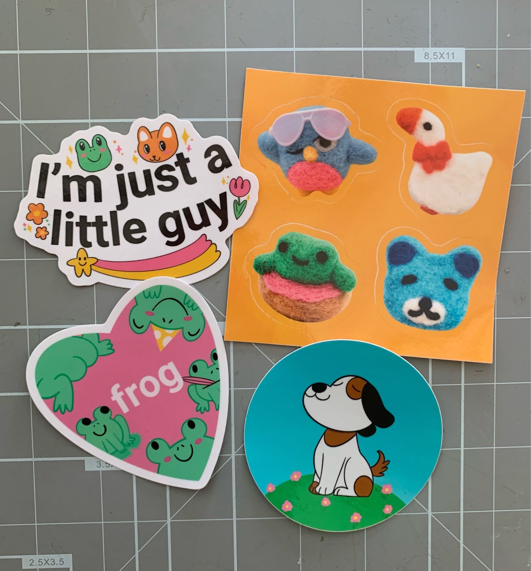 Four stickers, one saying “I’m just a little guy” and another with frogs