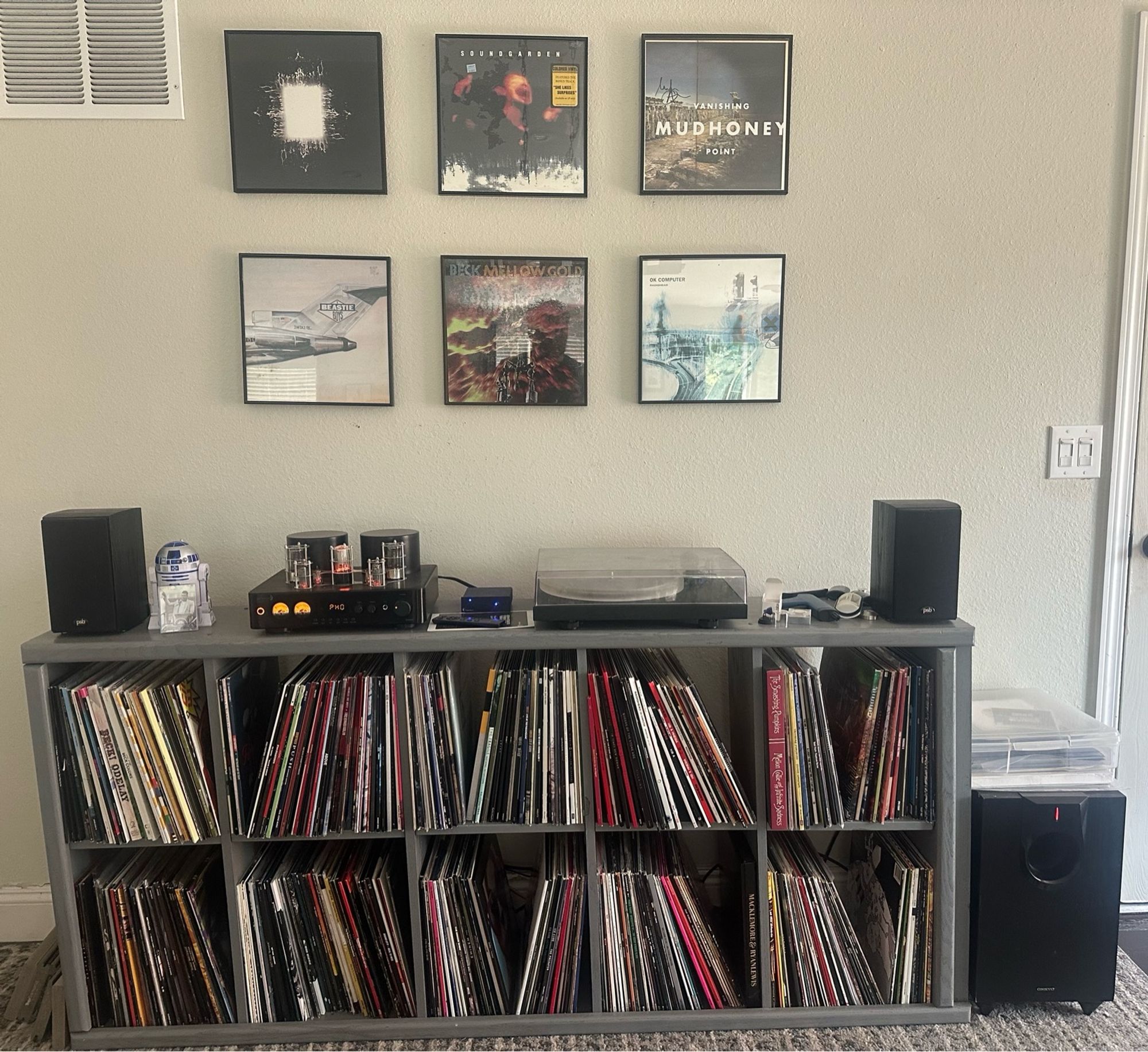 Living room listening station with; records, stereo, record player.