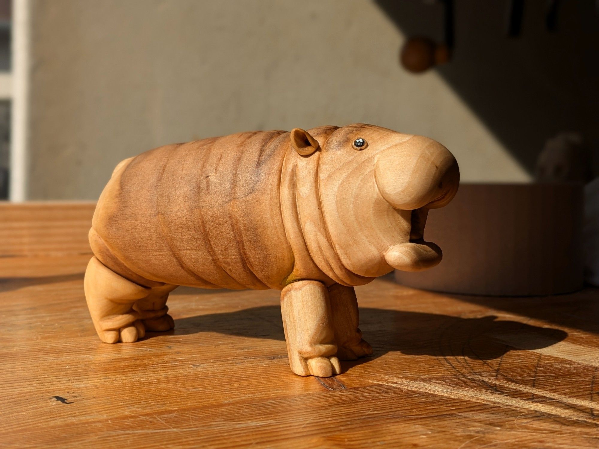 Woodcarved plump pigmy hippo (moo deng)