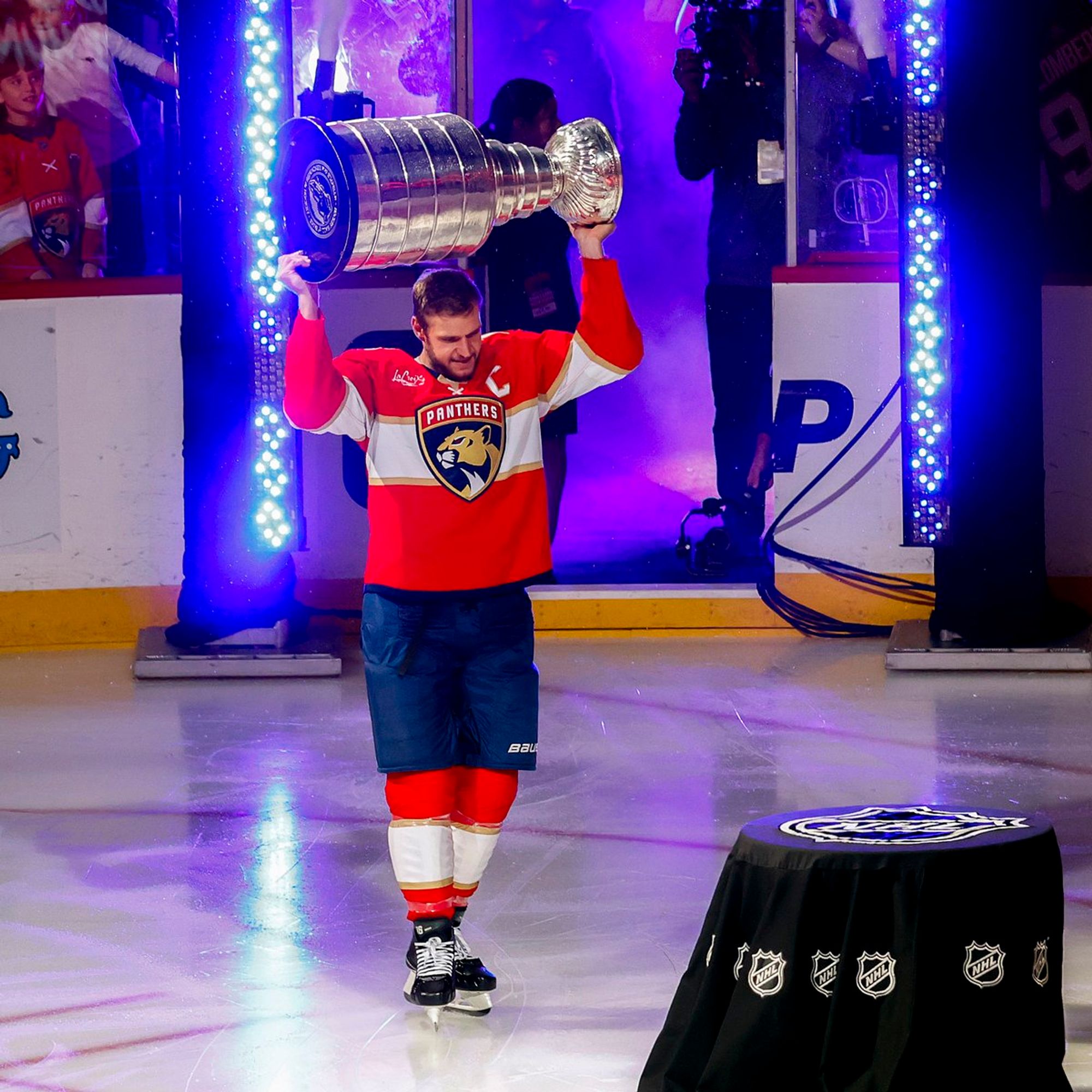 Photo of Aleksander Barkov skating with the Stanley Cup during the banner raising ceremony.