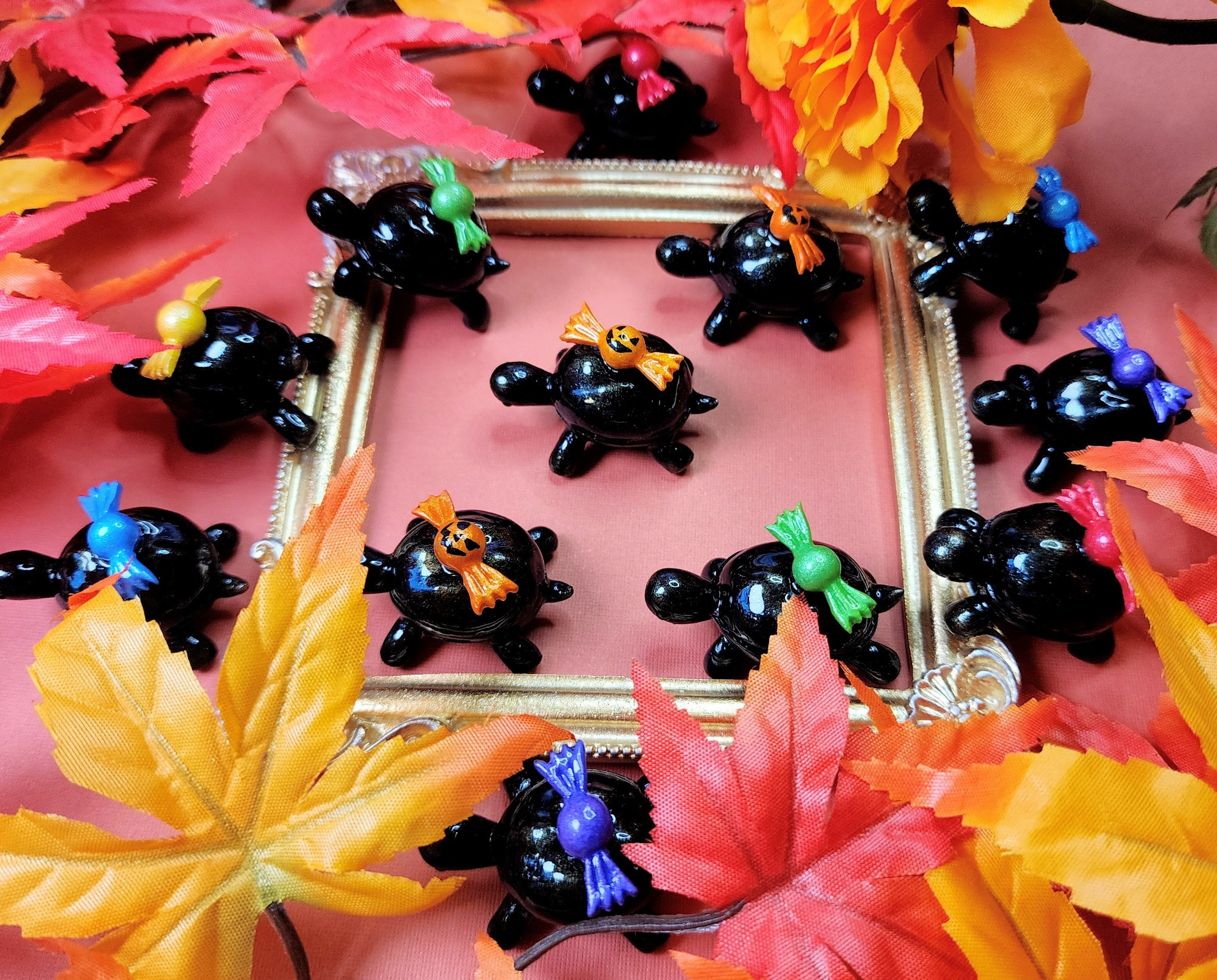 Little black turtle figures based off of over the garden wall. Each turtle has a random colored candy on their back like the show.