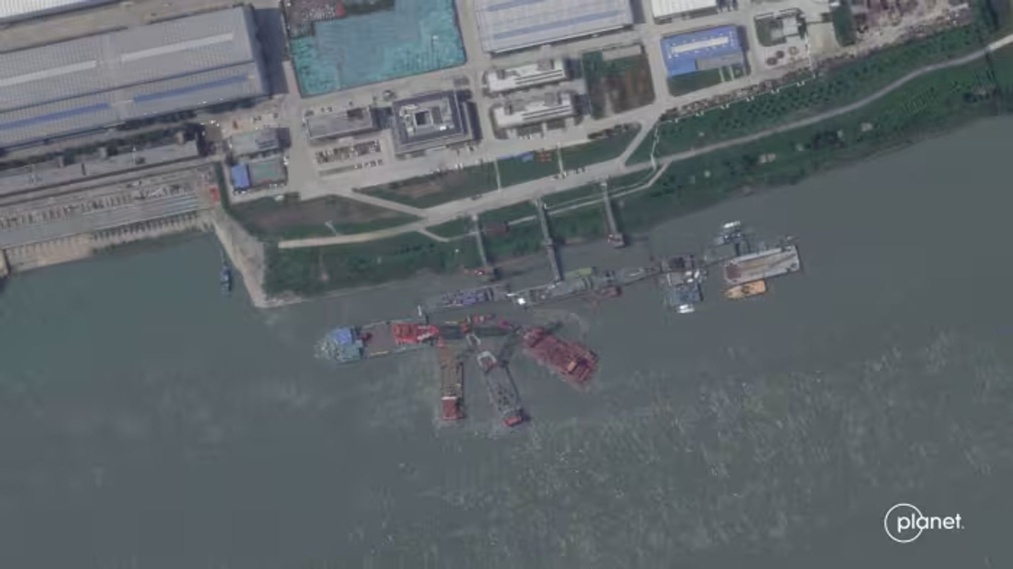 Satellite photo of the shipyard with floating cranes trying to recover the sunken sub in mid-June.