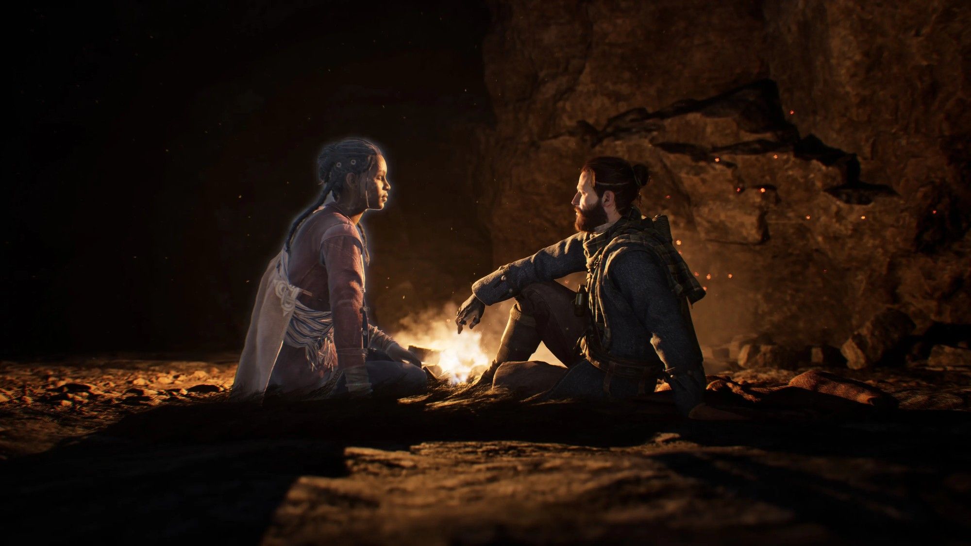 The game's two protagonists, a Scotsman and the ghost of a Cuban woman, sitting in front of a campfire.