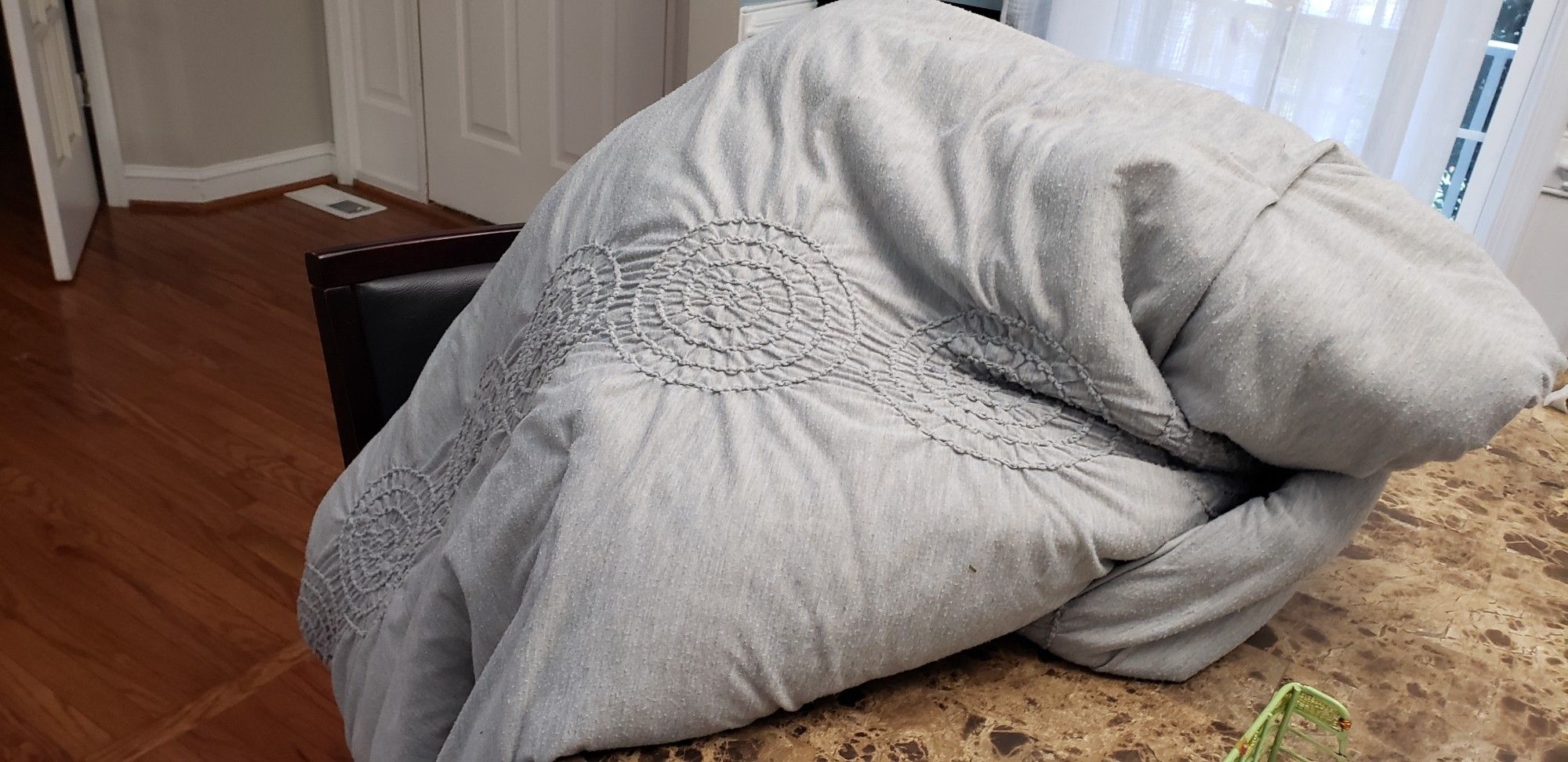 Daughter wrapped in gray blanket