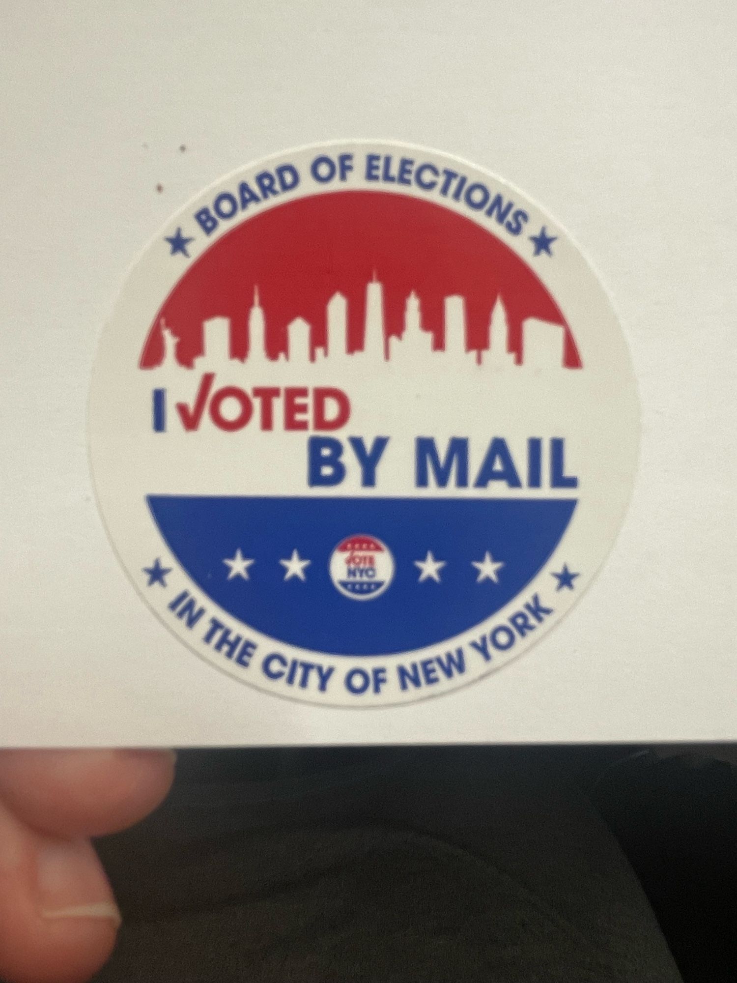 Red, white and blue sticker stating:

Board of Elections 
I voted by mail in the city of New York