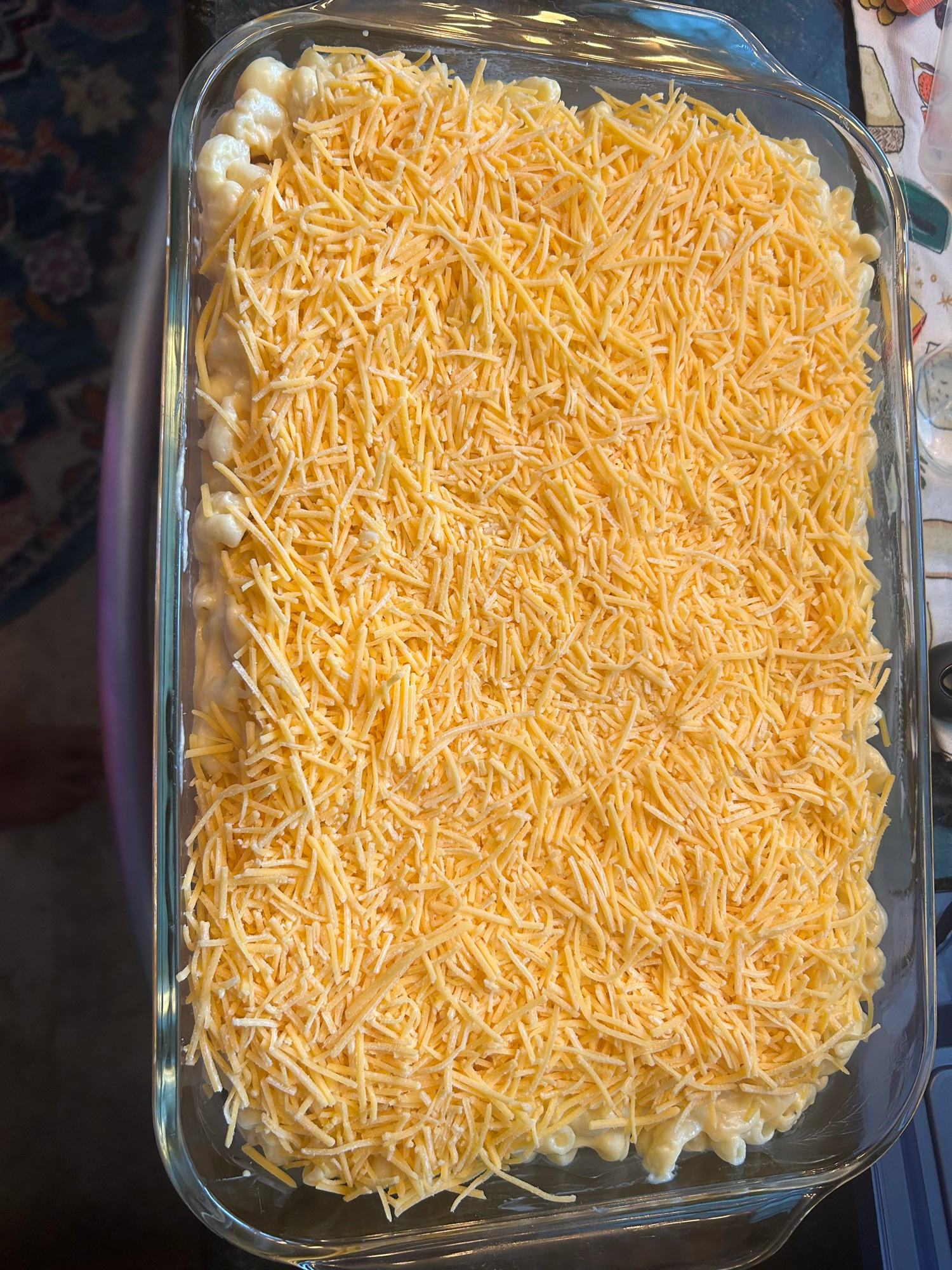 Mac and cheese topped with MORE CHEESE in a baking dish 