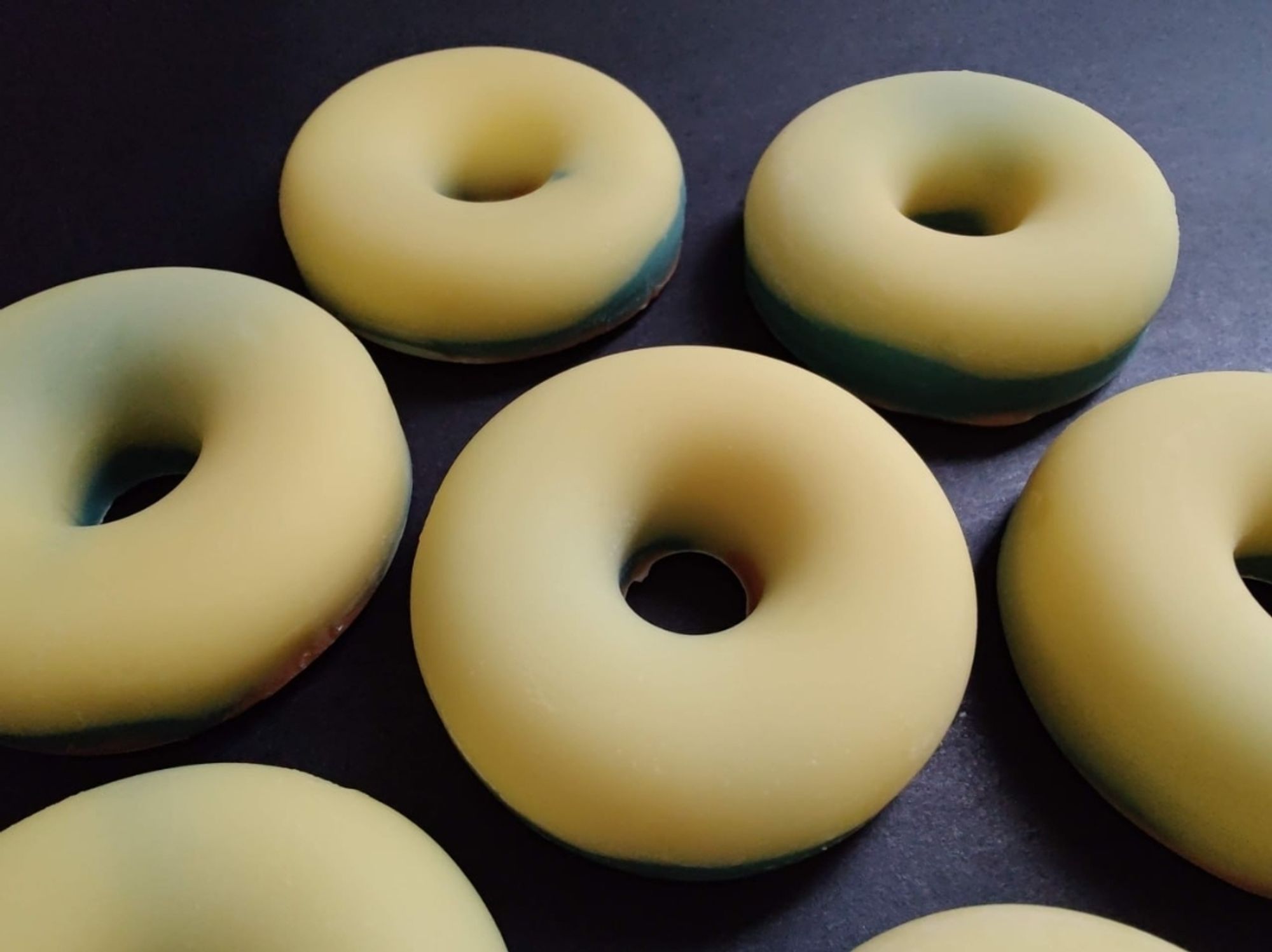 Several yellow and green doughnut shaped soaps