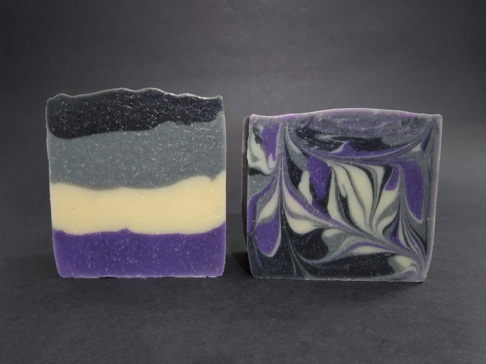 Two bars of Asexual colored soaps. The left is layered and the right is swirled. They are scented in cherry limeade.