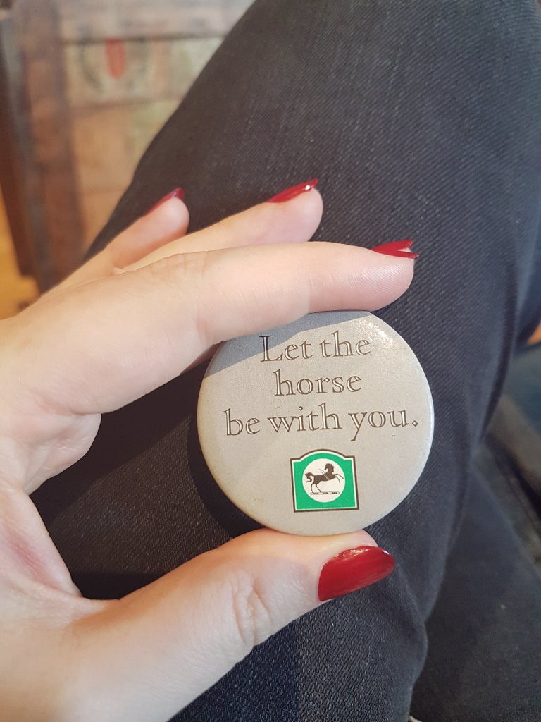 A round plastic vintage pin badge from Lloyds Bank with their black horse logo and the words "Let the horse be with you." 

Let. LET.