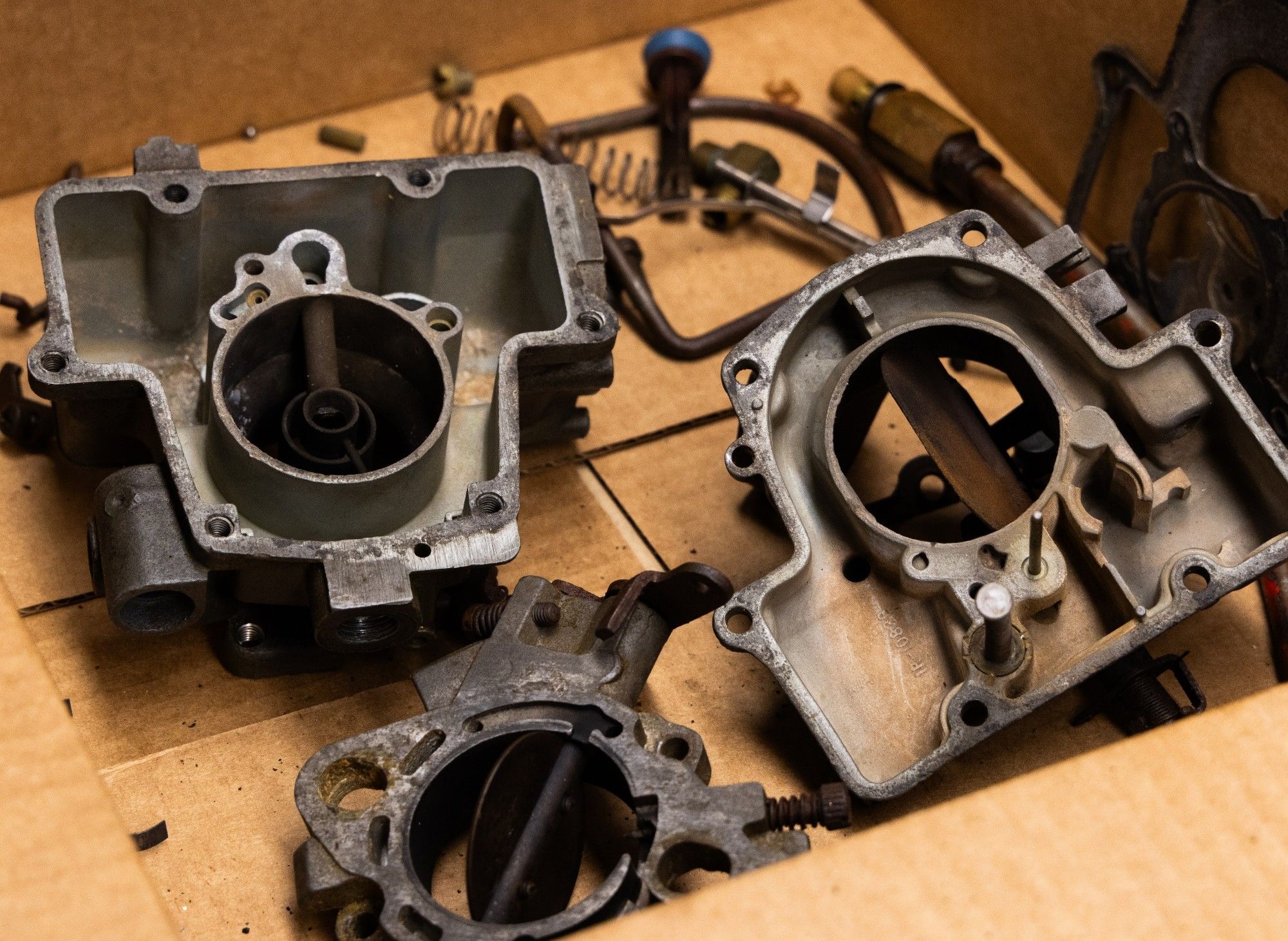 A parts of a carb sitting to be cleaned