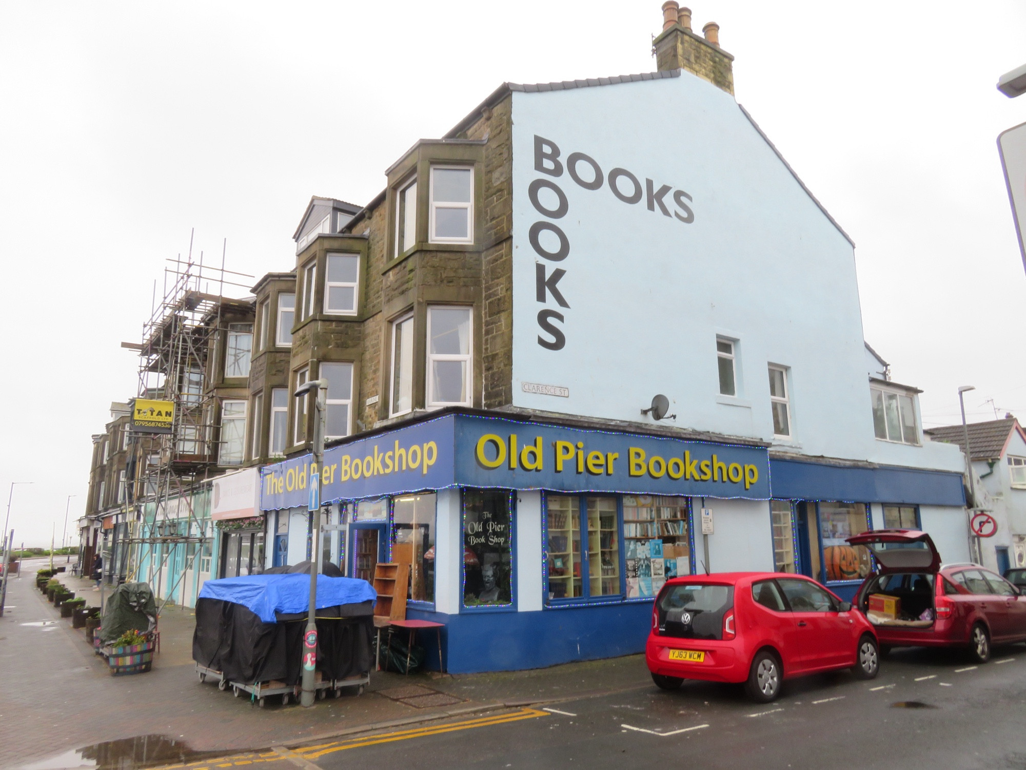 The Old Pier Bookshop, Morecambe, UK.

A 3-storey corner shop, with blue sign boards and yellow writing.